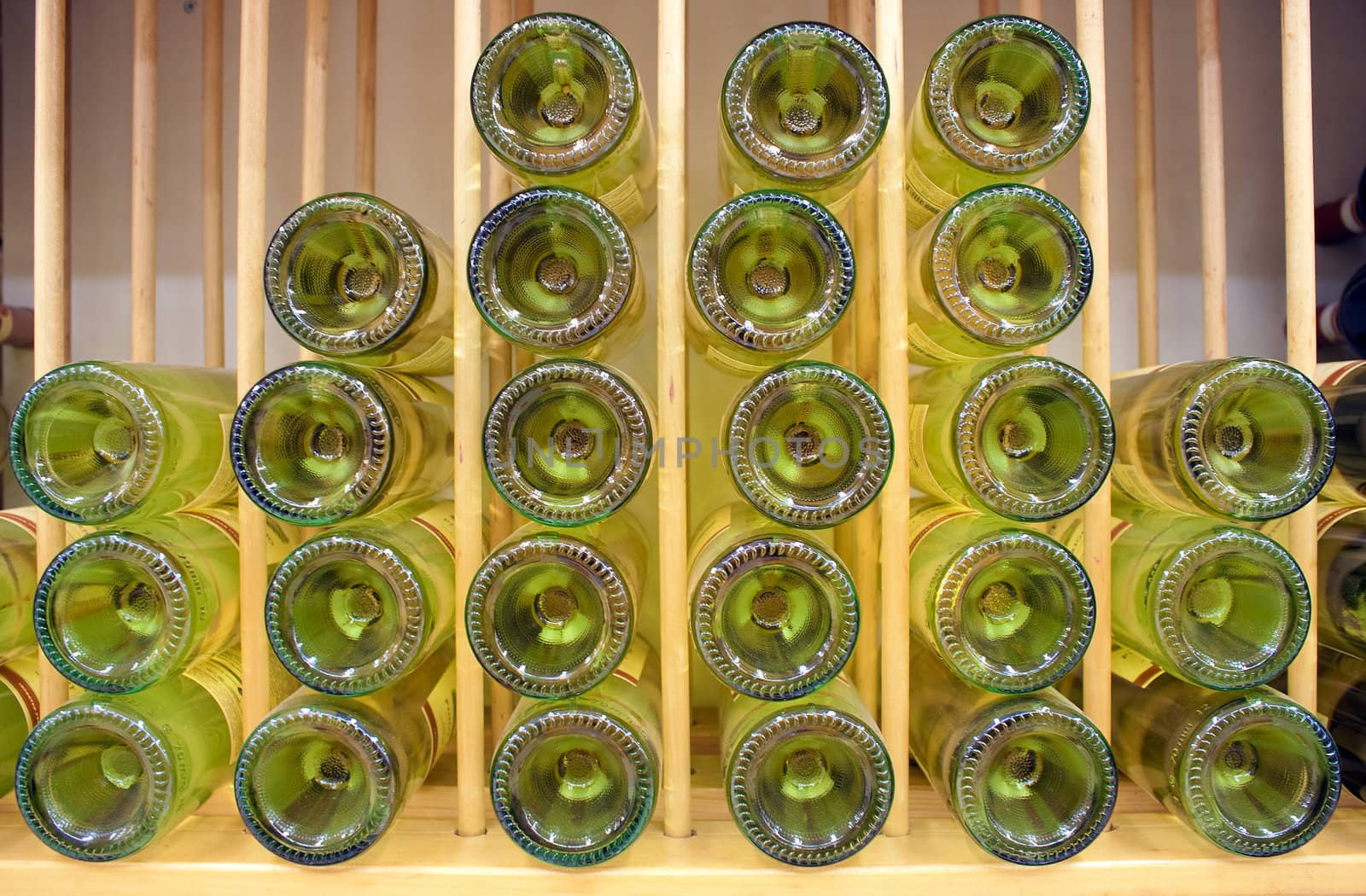 White wine bottles stacked on top of each other with narrow depth of field