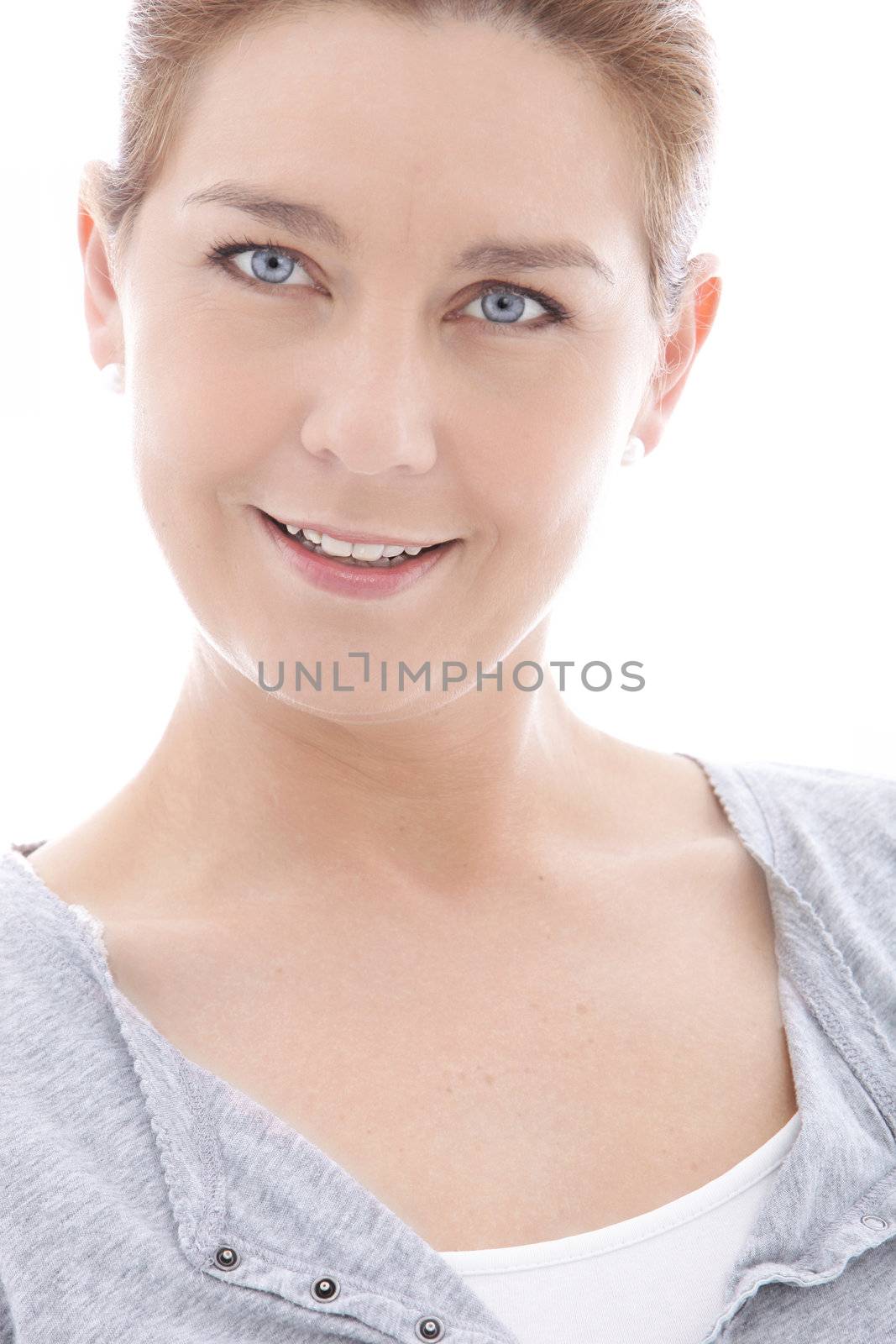 Attractive blue eyed mature woman looking directly at the camera with a smile, isolated on white