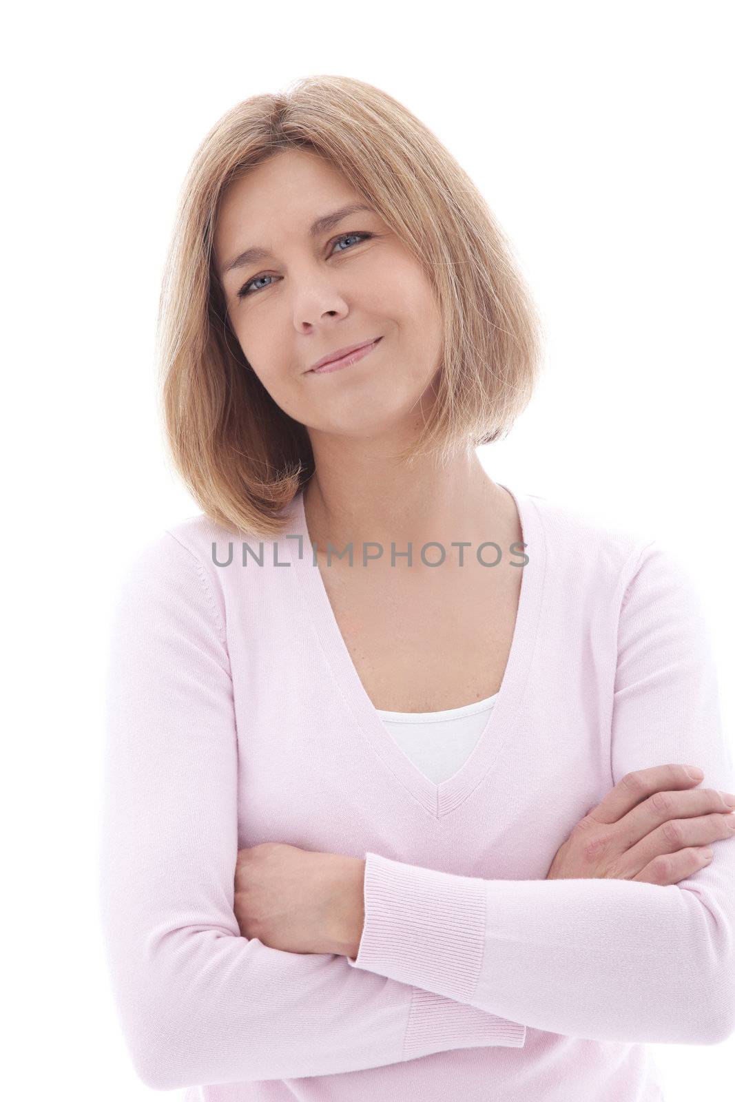 Smiling attractive mature woman with folded arms standing looking pensively at the camera, isolated on white