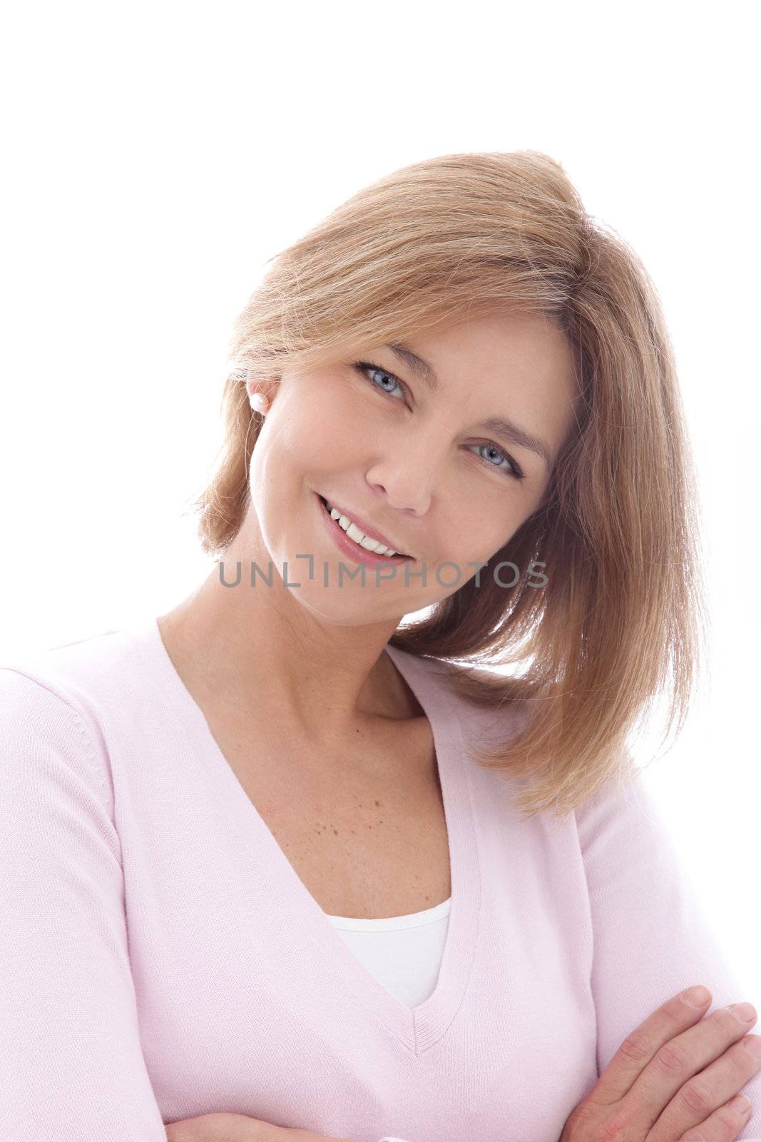 Smiling beautiful mature woman with her head tilted to the side looking at the viewer, head and shoulders isolated on white