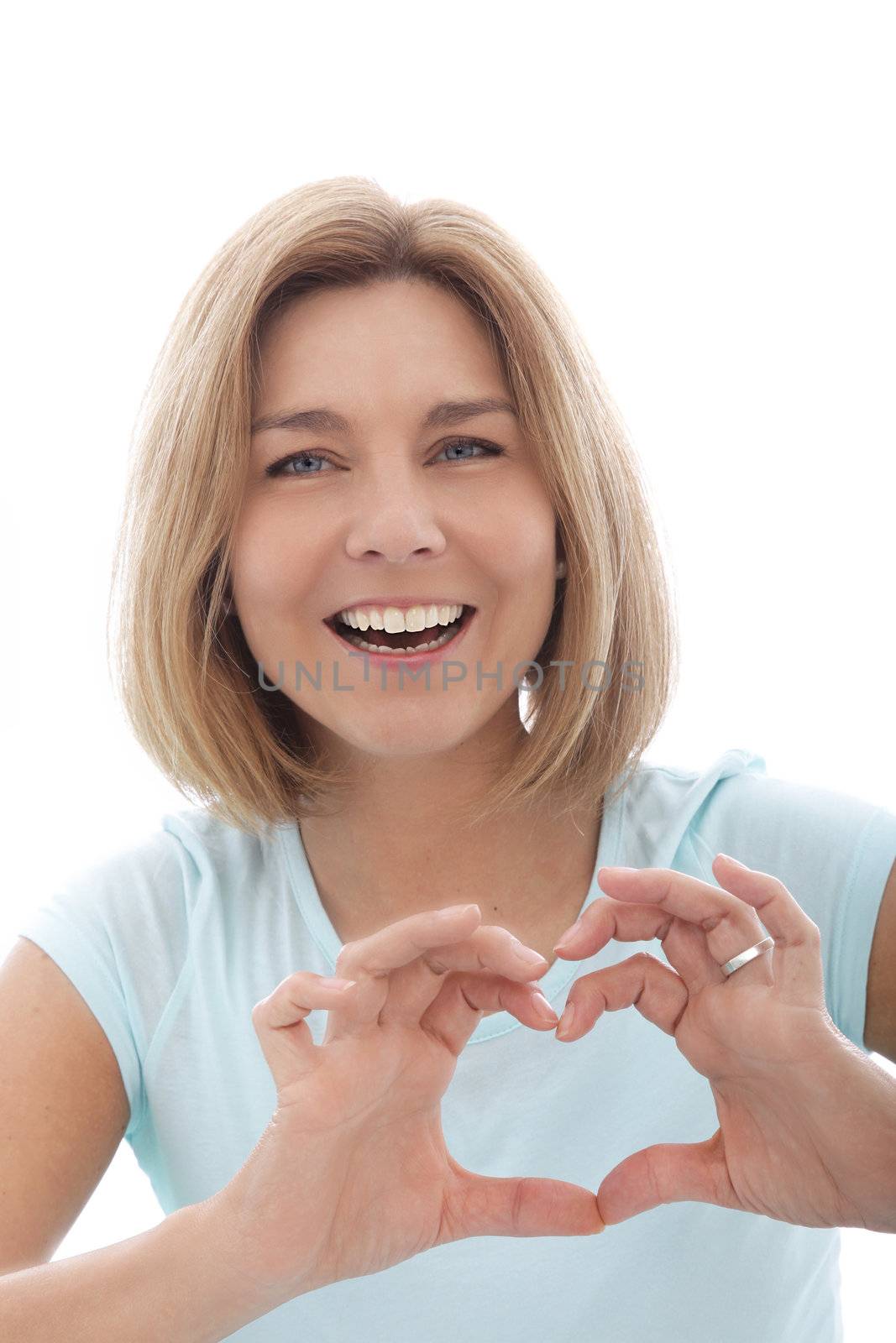 Laughing woman making a heart gesture with her fingers to show her love for something, isolated on white