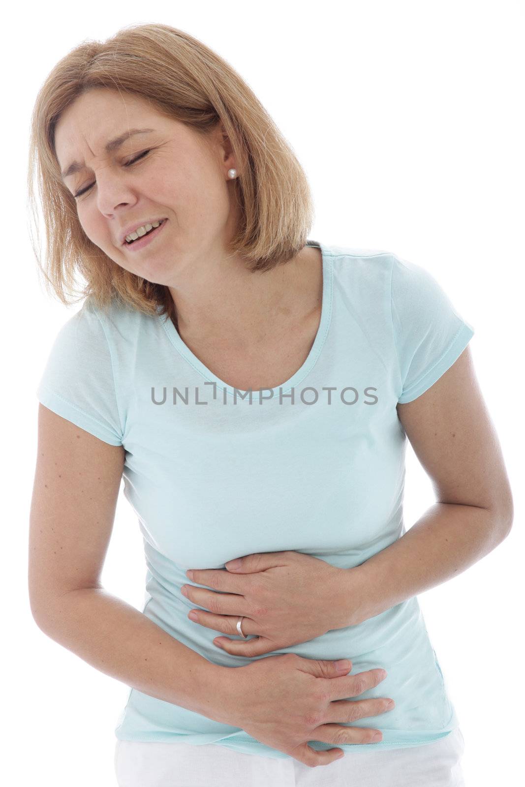 Woman with stomach pain clutching her tummy with both hands while grimacing in anguish, isolated on white