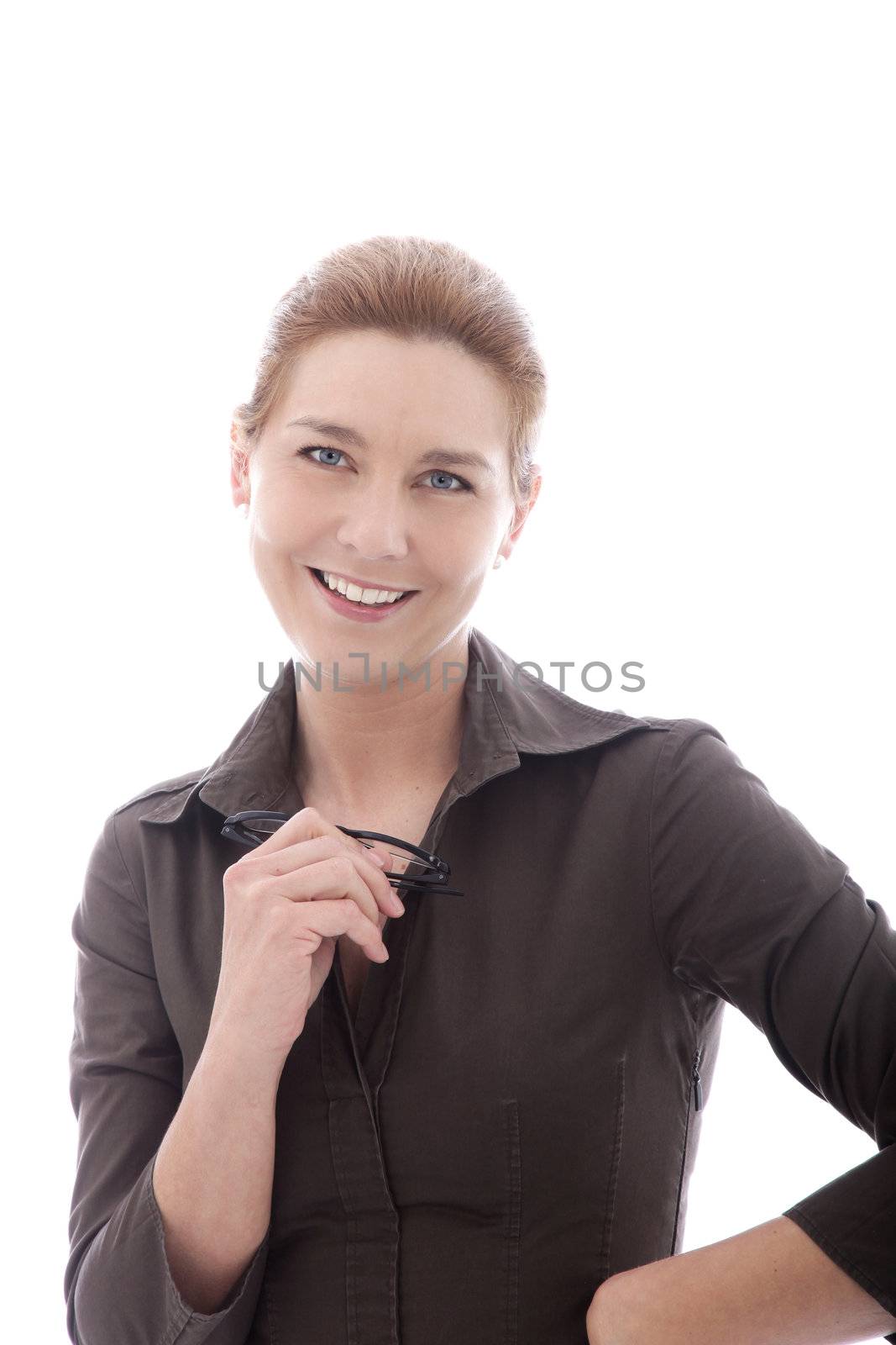 Smiling mature businesswoman with neatly tied back blond hair and a stylish shirt holding her glasses and smiling at the viewer, isolated on white