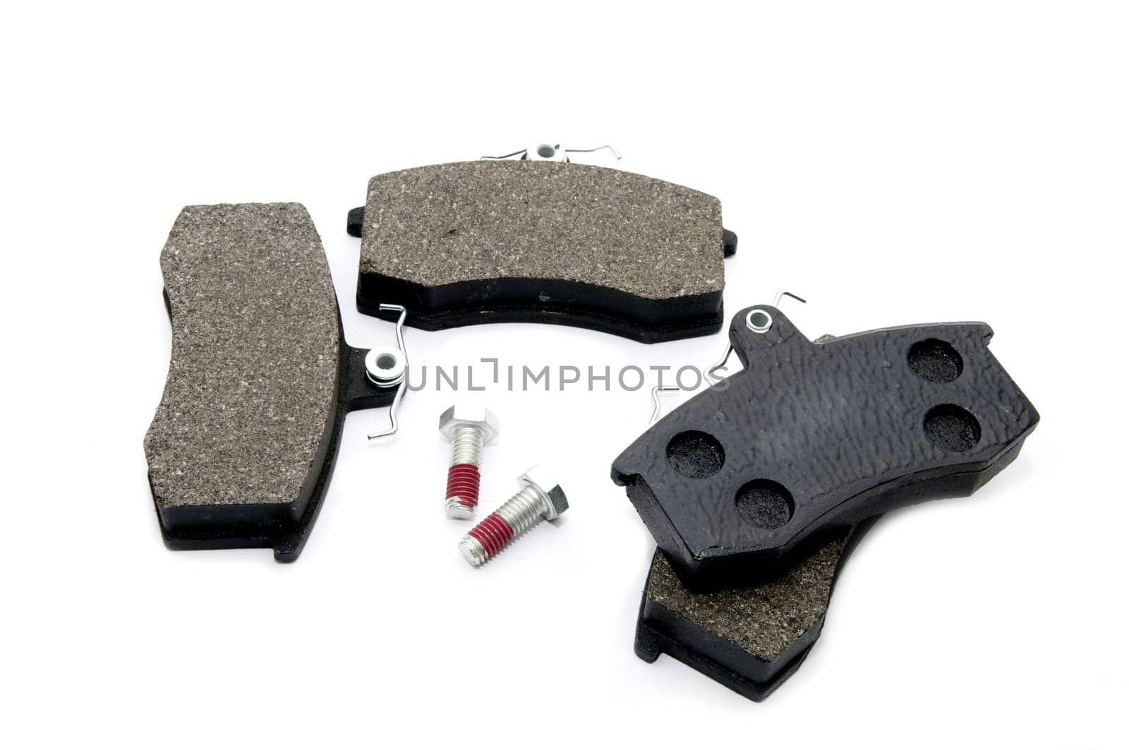 set of brake pads for a car on a white background