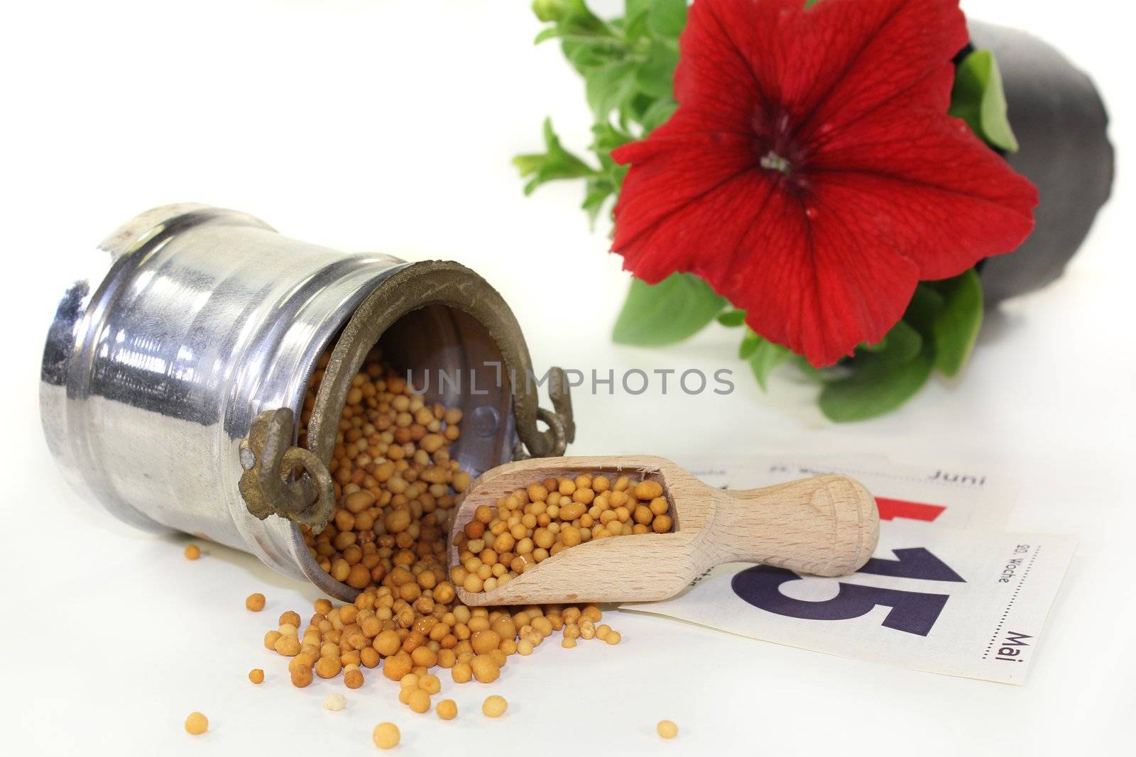 a bucket of slow release fertilizer in front of white background