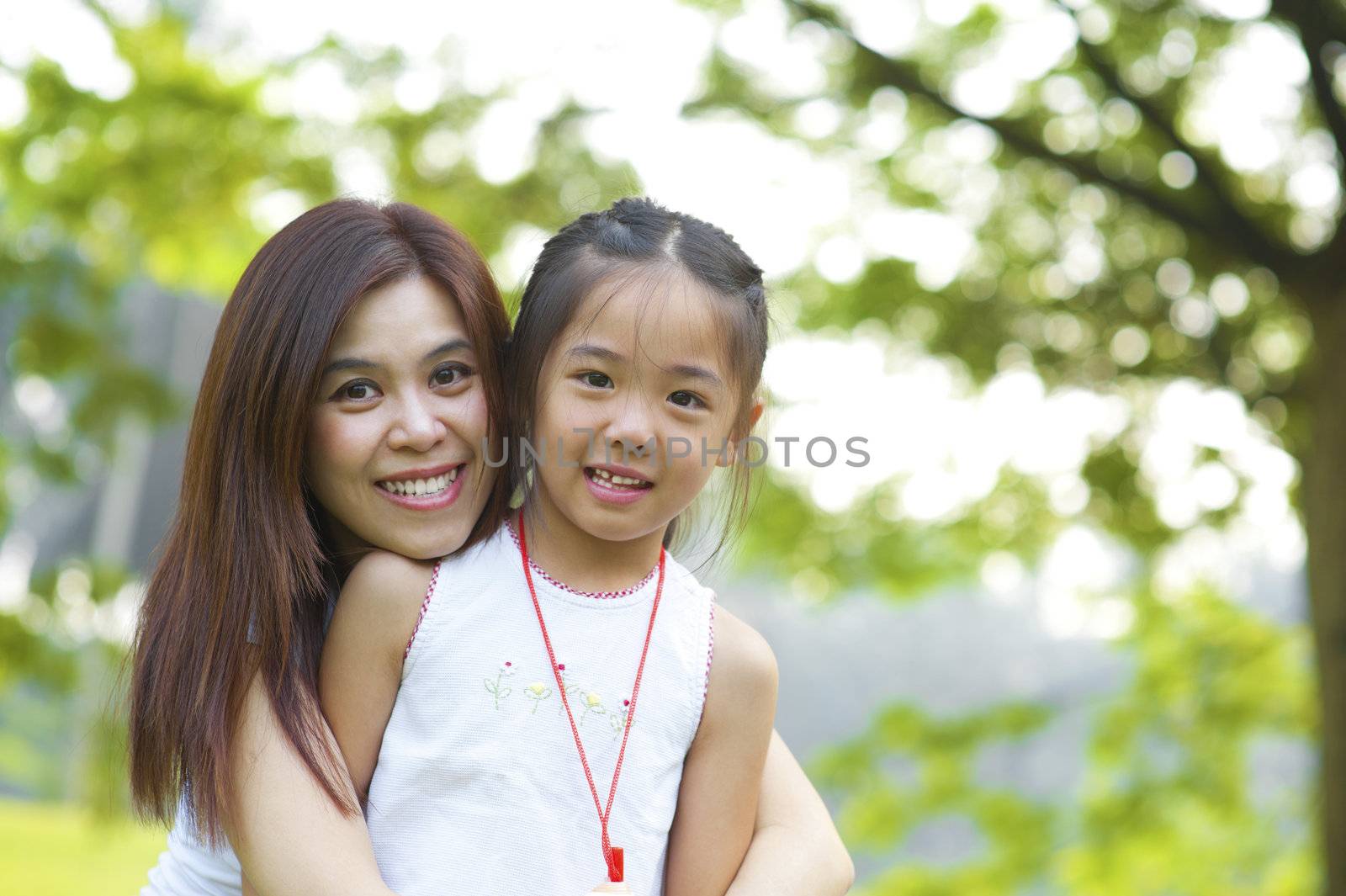 Outdoor park happy Asian mother and daughter