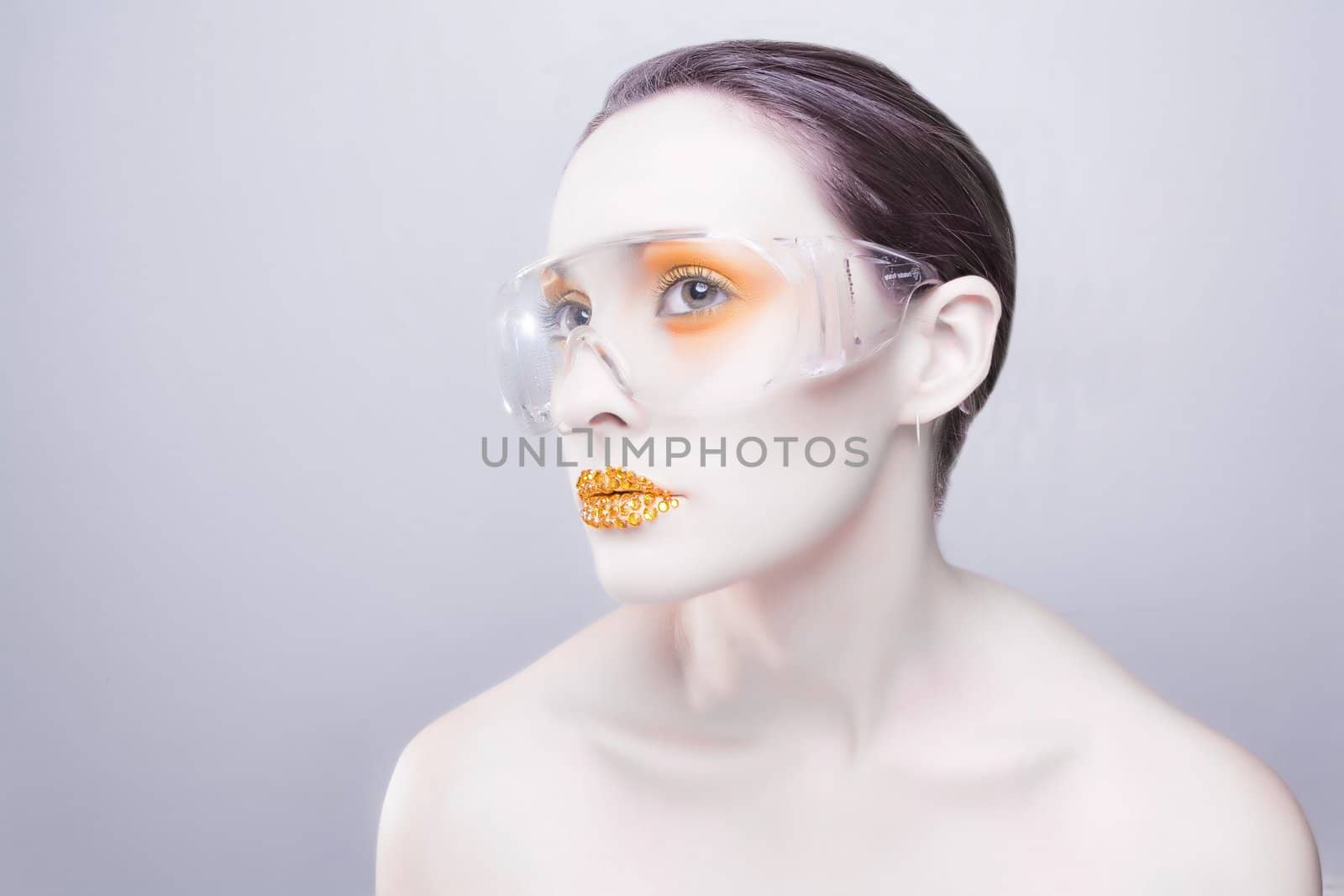 Young caucasian woman with gold fashion makeup by hangingpixels