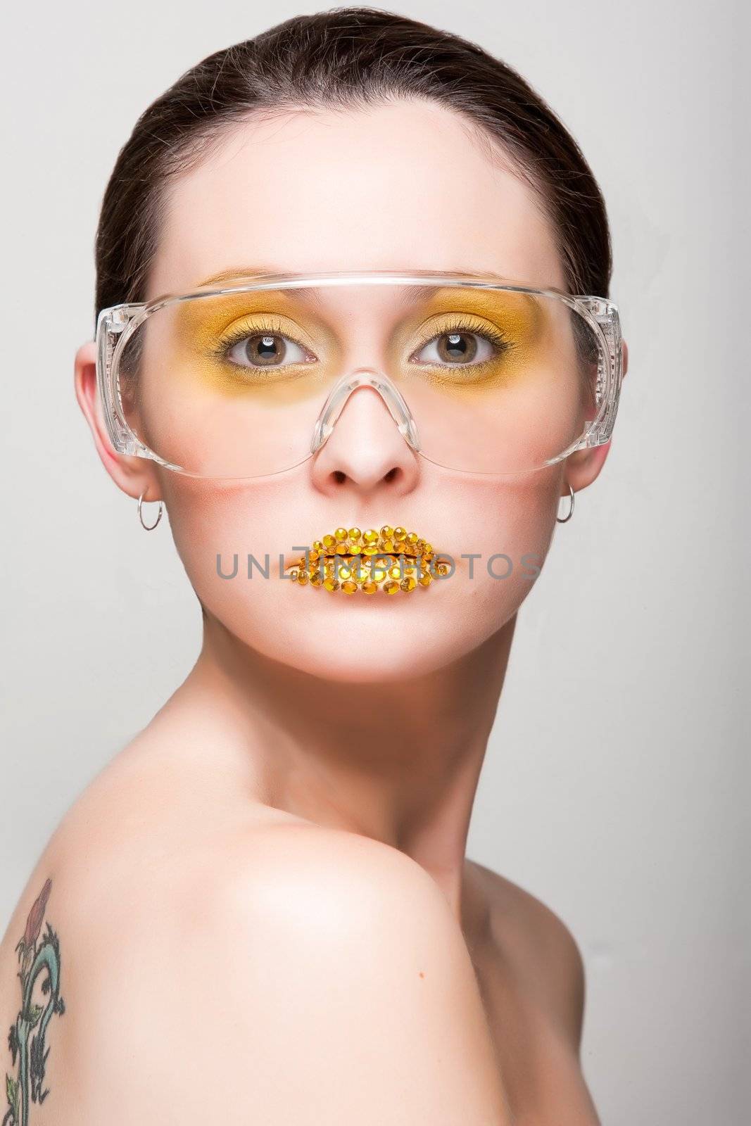 Young caucasian woman with gold fashion makeup by hangingpixels