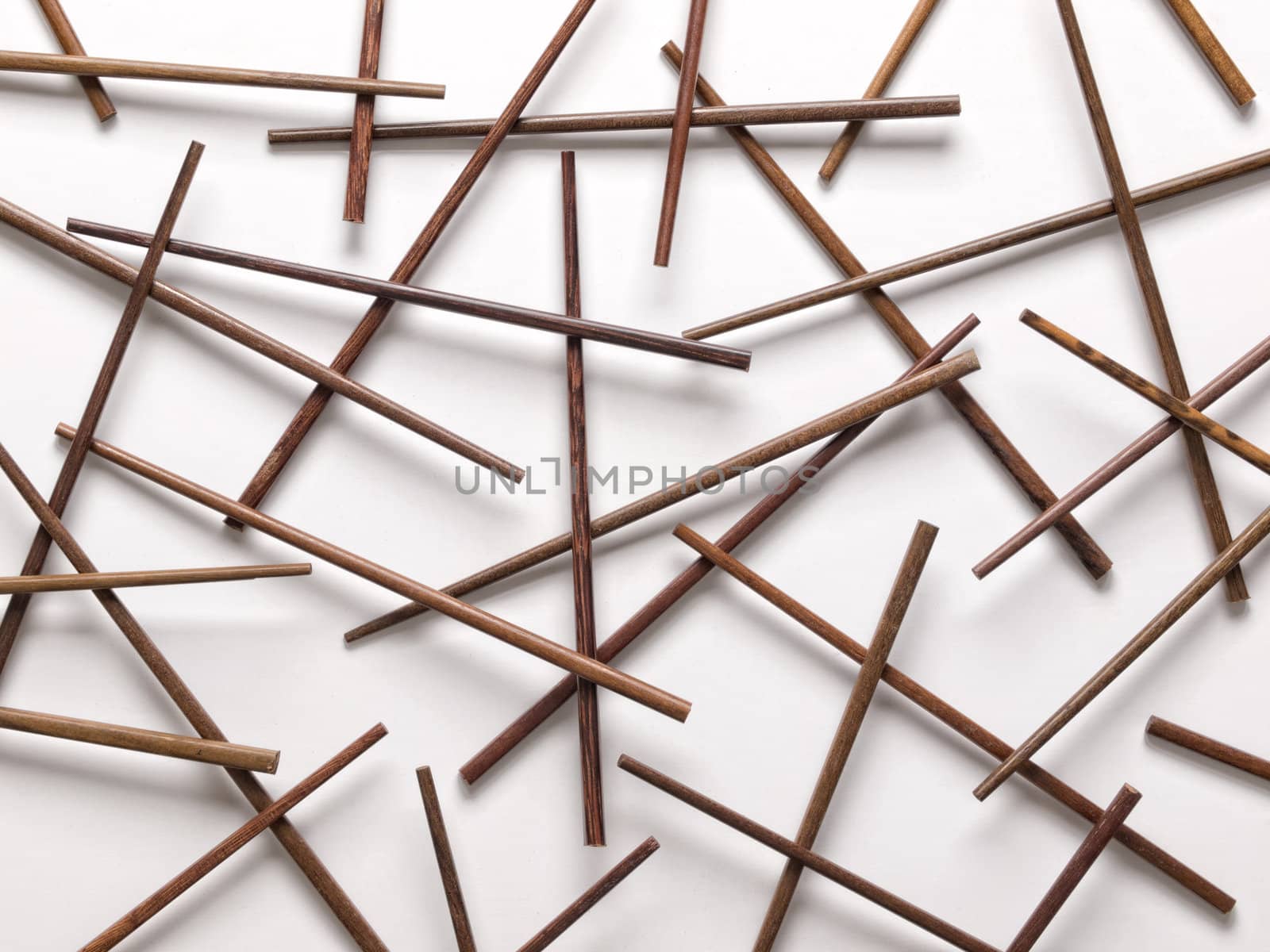 close up of wooden chopsticks on white