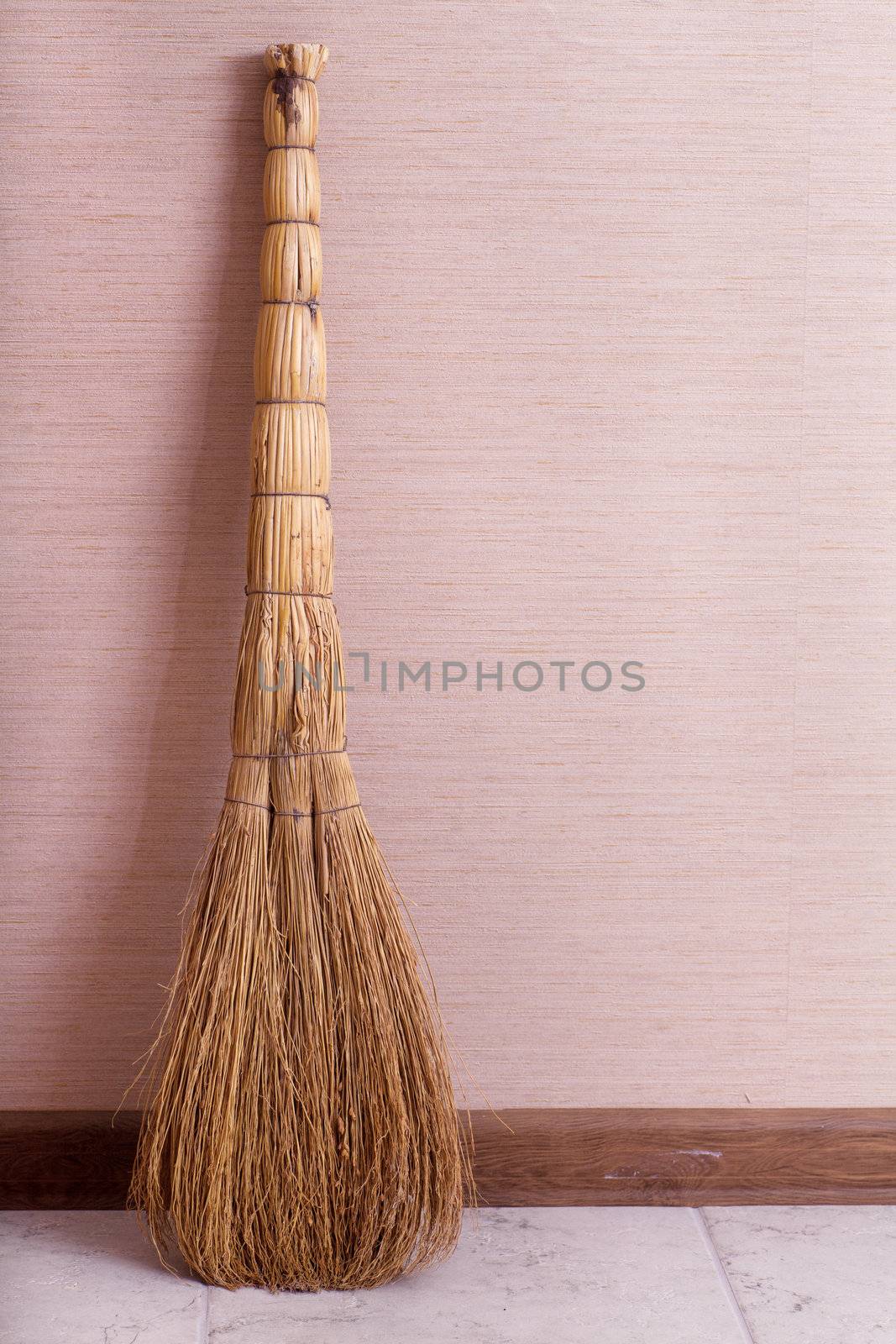 Whisk broom standing in empty room