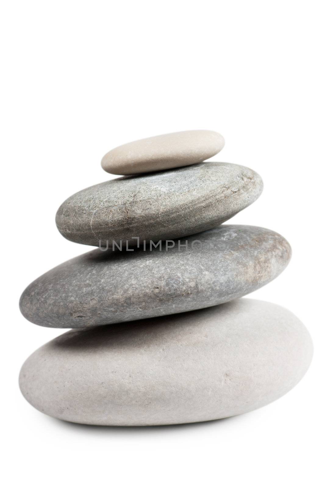 Stack of four round stones isolated over white background