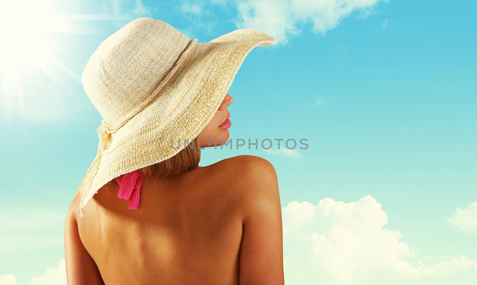 Fashionable woman with straw hat protects from sun