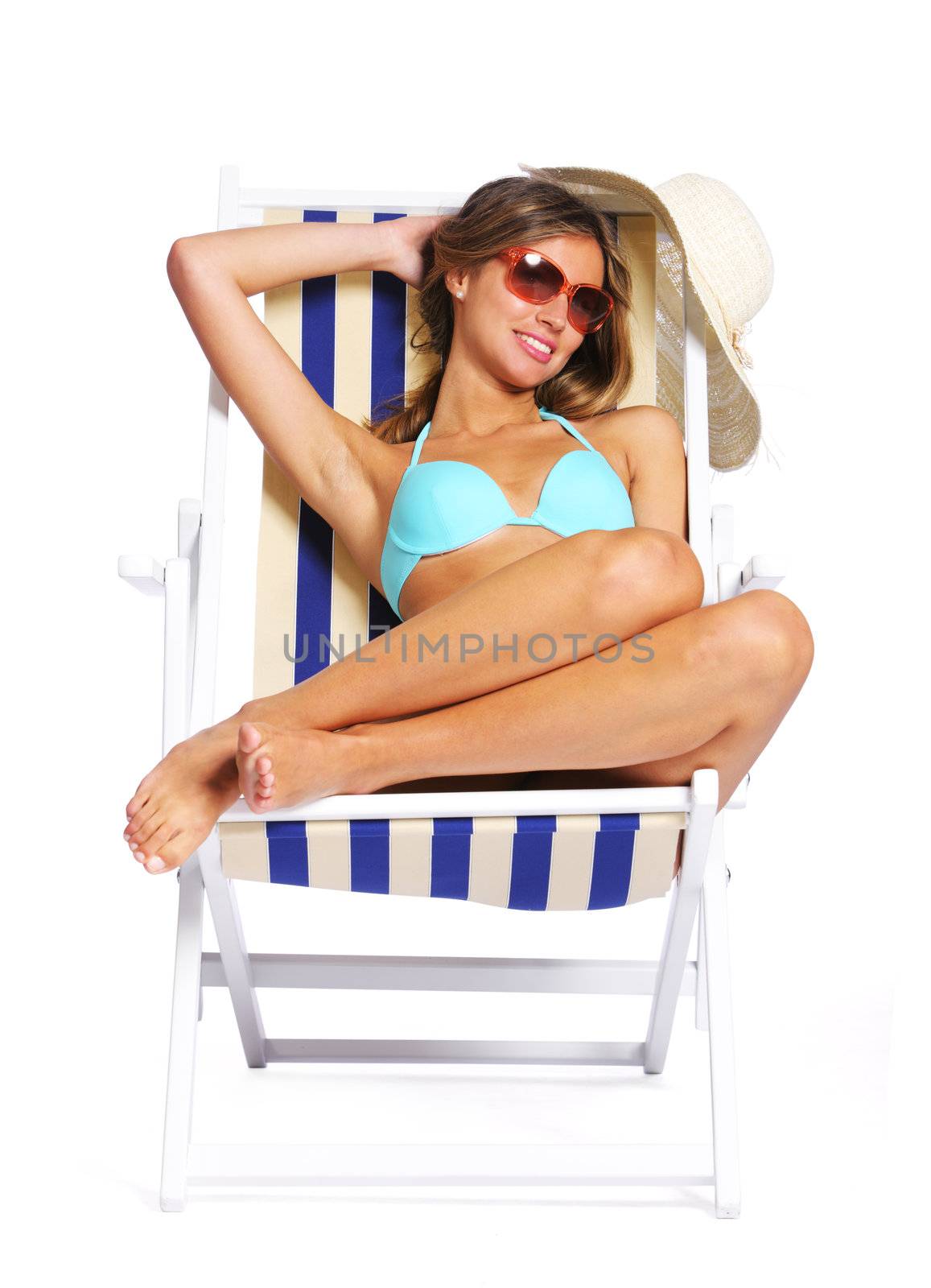 Beautiful young woman relaxing on beach chair, white background