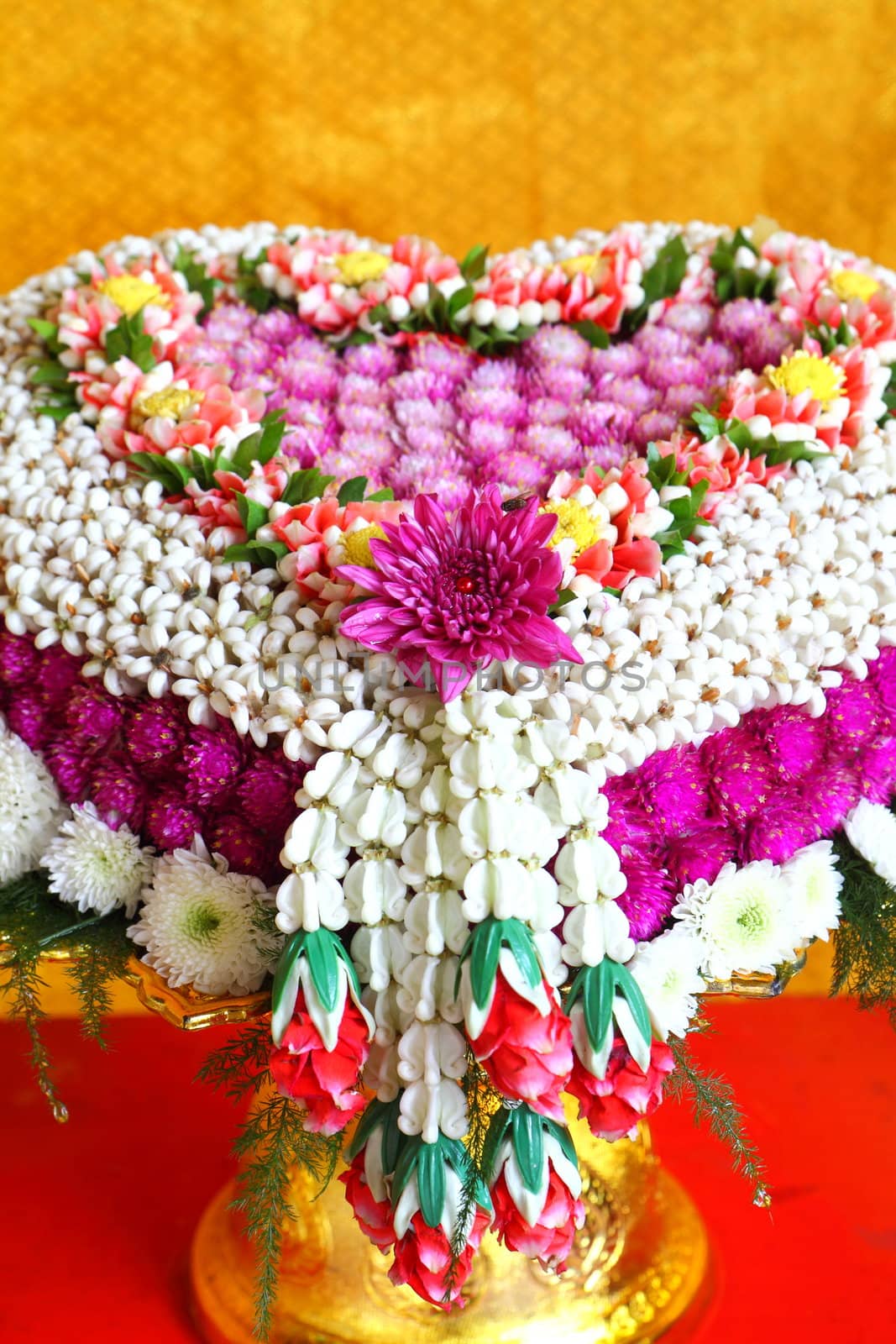 Thai flower heart shaped garland on golden tray with pedestal use for blessed water in Thai wedding ceremony