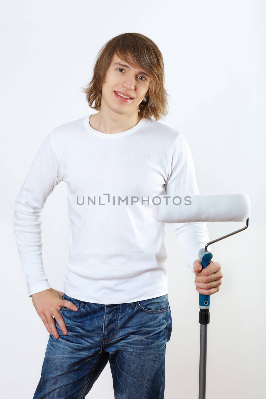 Portrait of young man with paint brushes