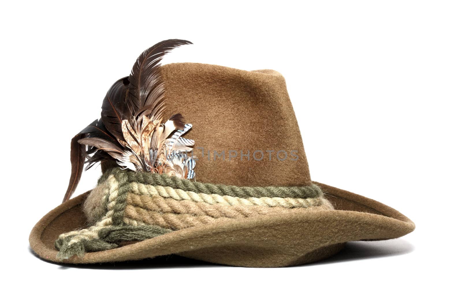vintage woolen hunting hat decorated with feathers over white background