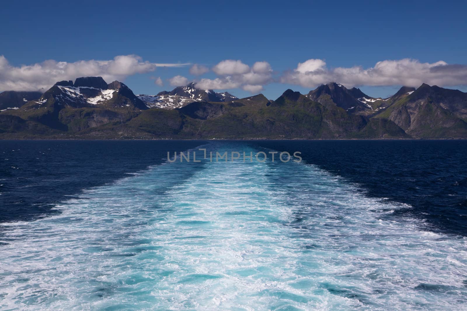Wall of towering mountain peaks on Lofoten islands in Norway from the local ferry