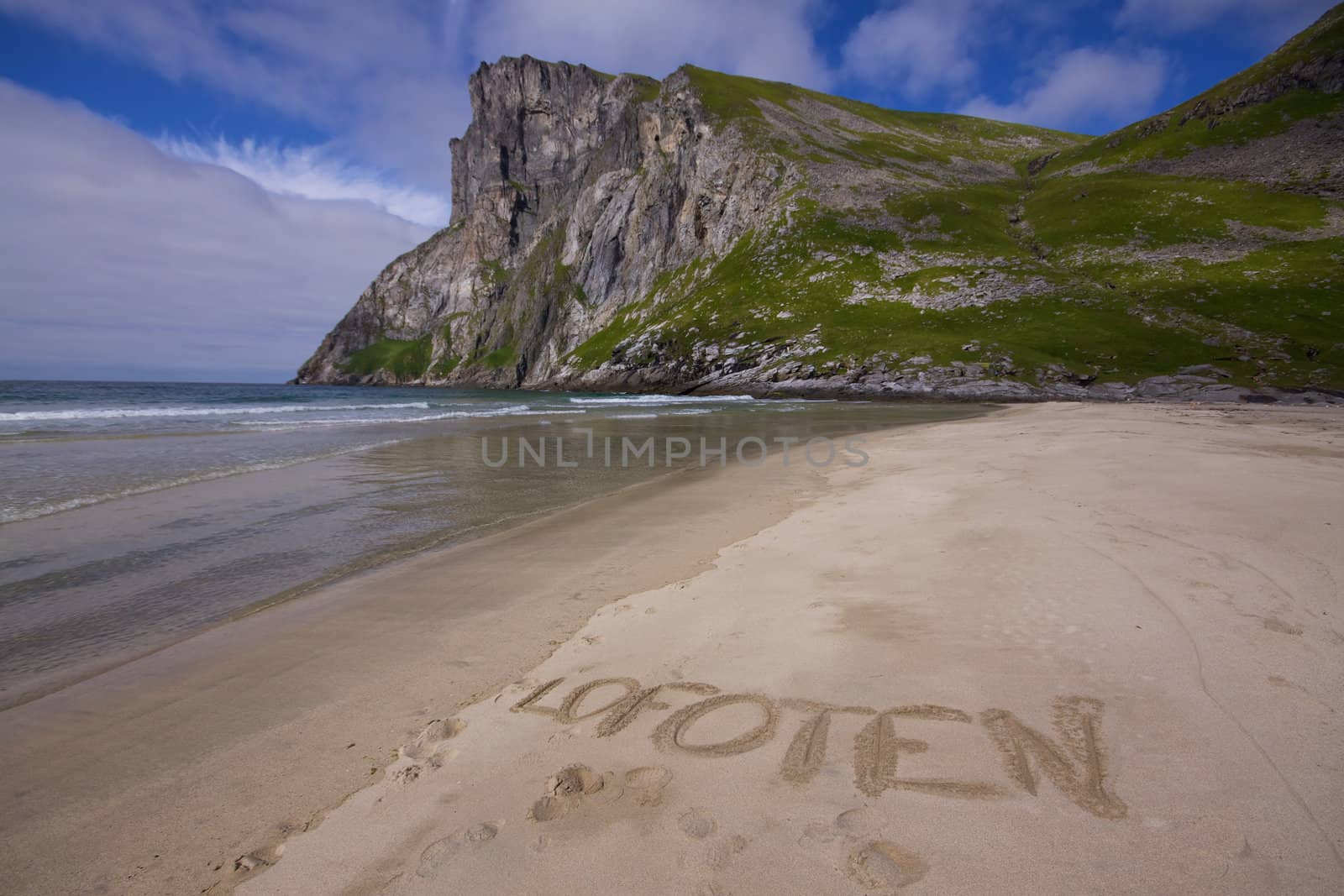 Picturesque beach on Lofoten islands in Norway with word "Lofoten" written in the sand