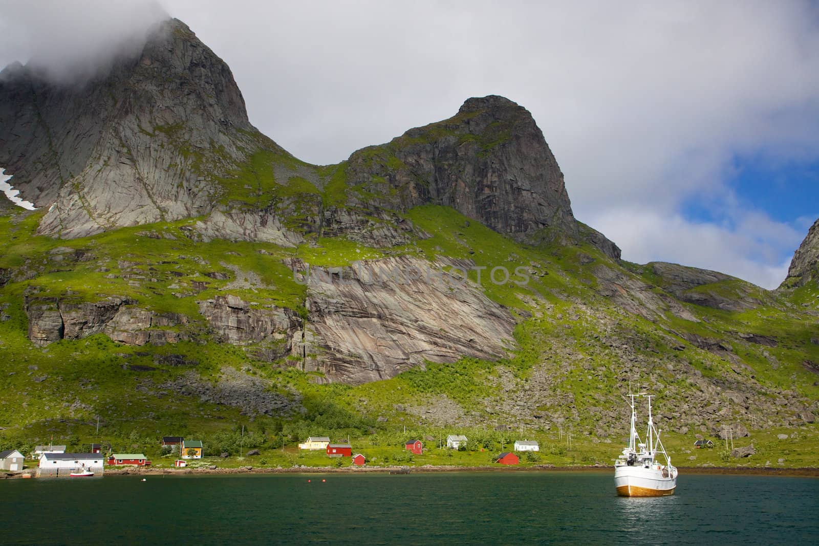 Fishing boat in fjord on Lofoten islands in Norway