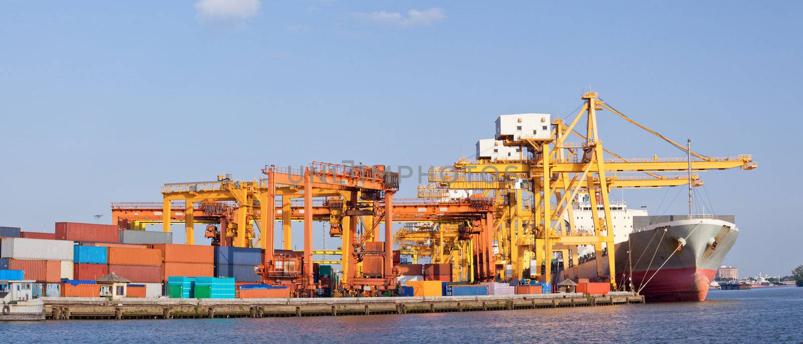 Panorama of Cargo industrial ship unloading goods at Terminal Port