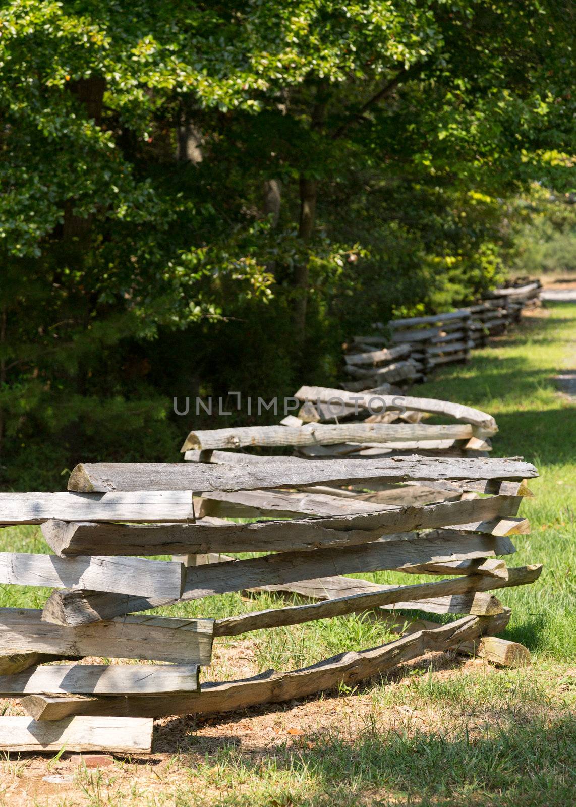 Traditional split rail fence by side of woods or forest