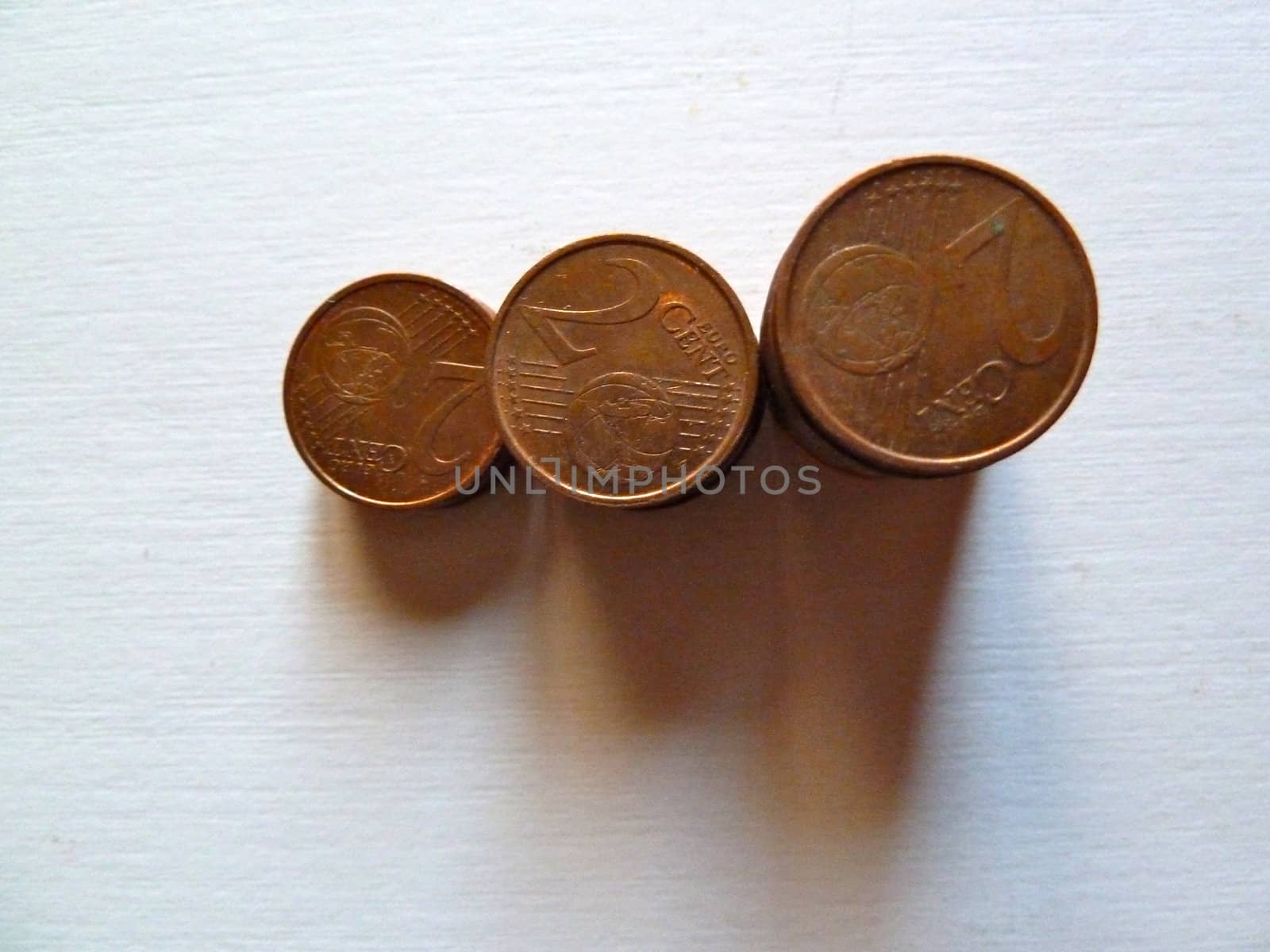 stack of brass coins on a white background