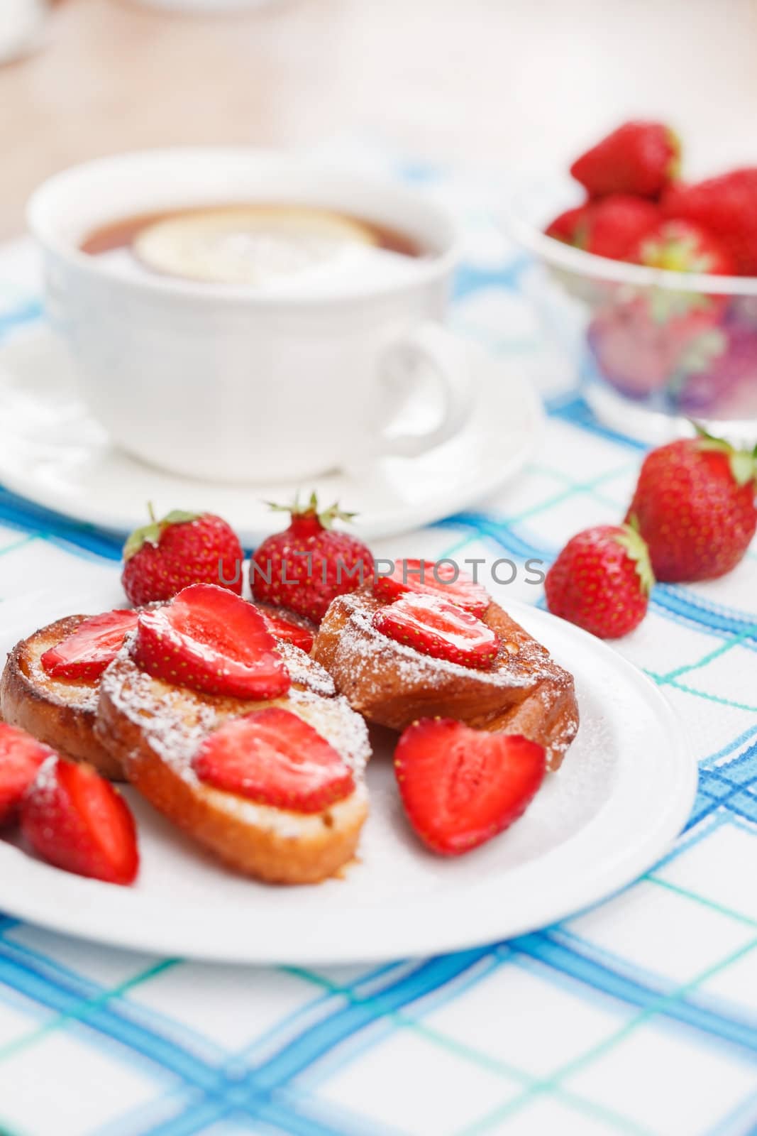 French toasts with powdered sugar and a strawberry by shebeko