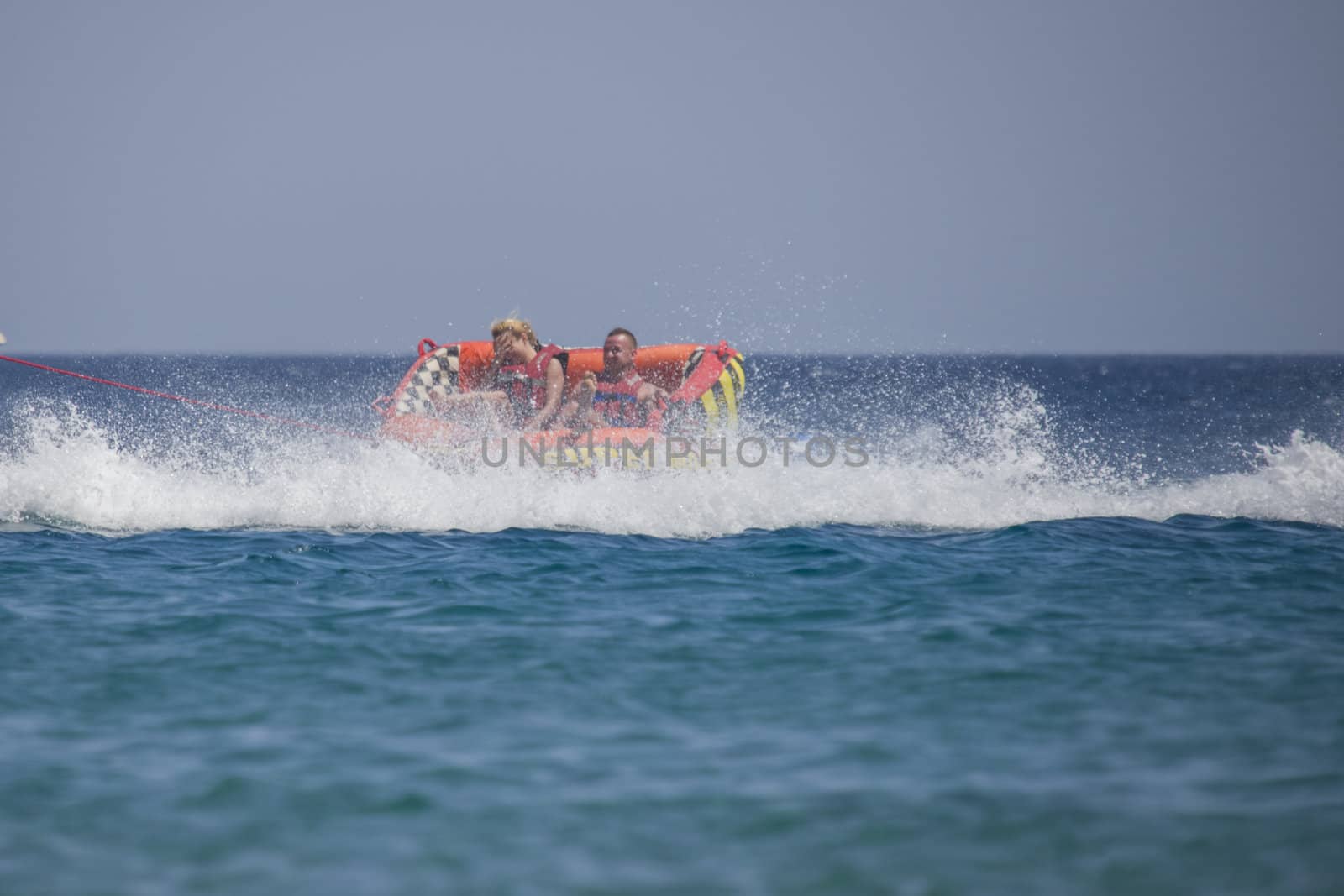 The speed boat kept probably a little too fast speed when the rubber boat with two people overturned. The picture is shot from the beach in Naama Bay one day in April 2013.