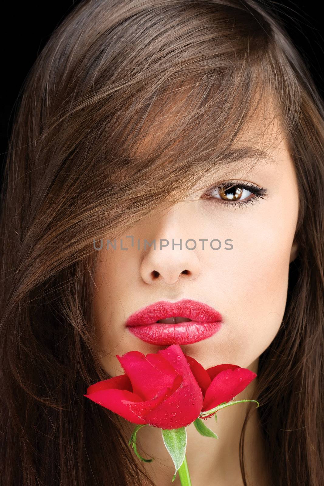 Pretty young brunette woman and red rose