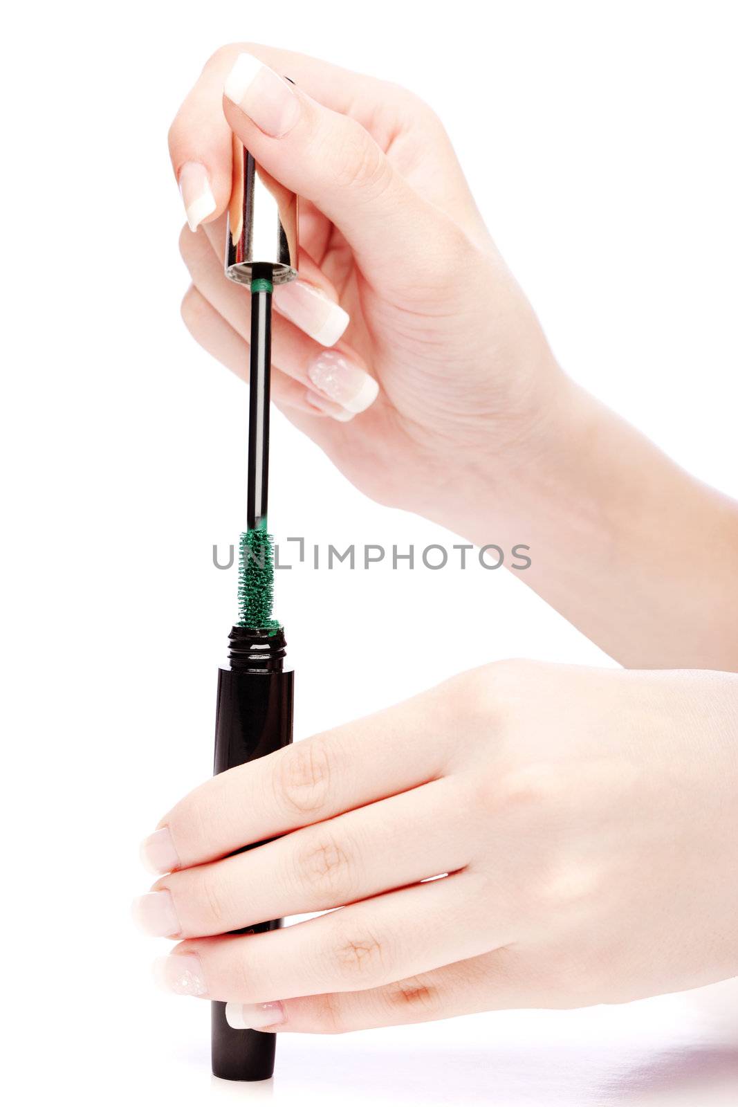 Mascara in woman's hand, isolated on white