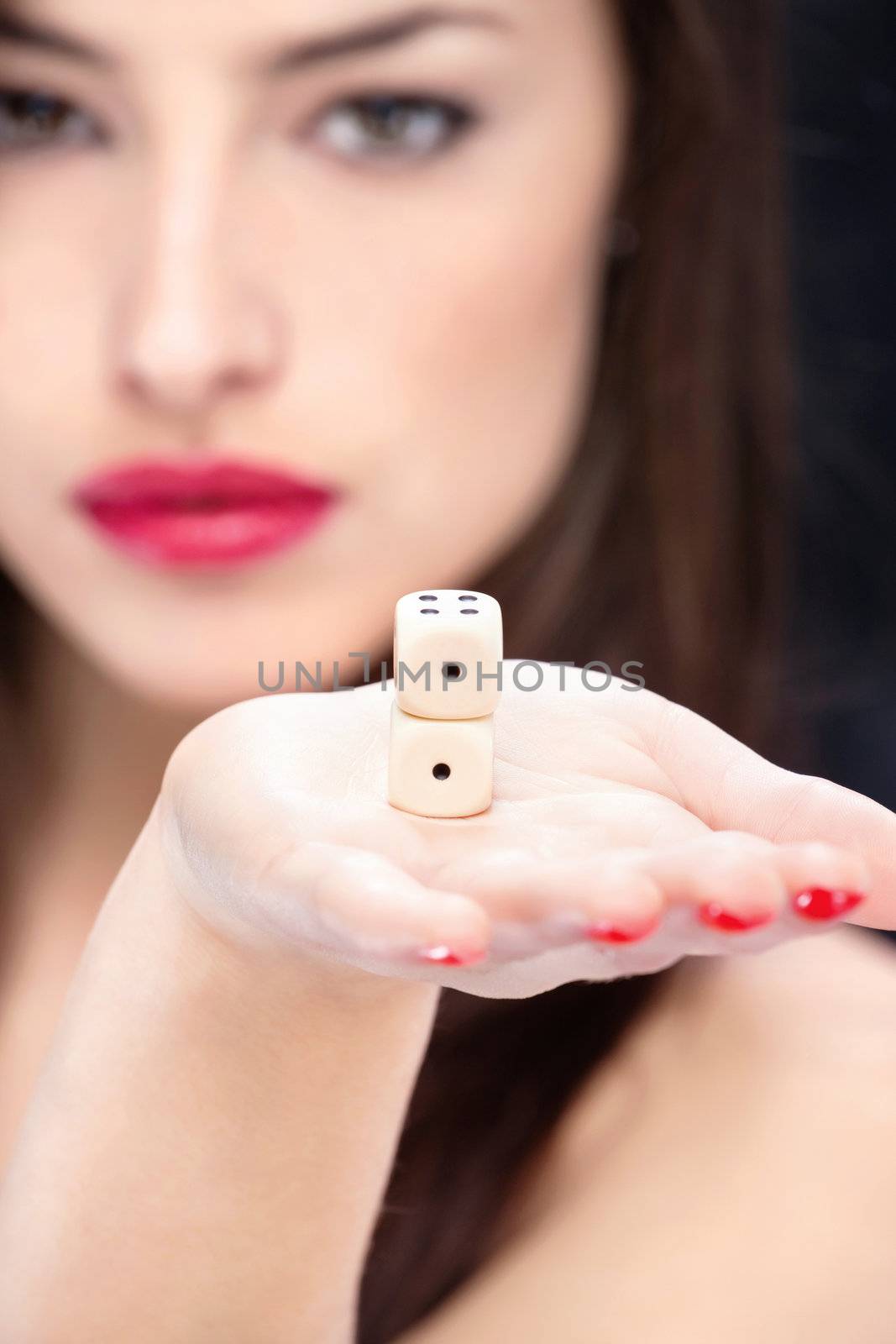 Two dices in young woman's hand