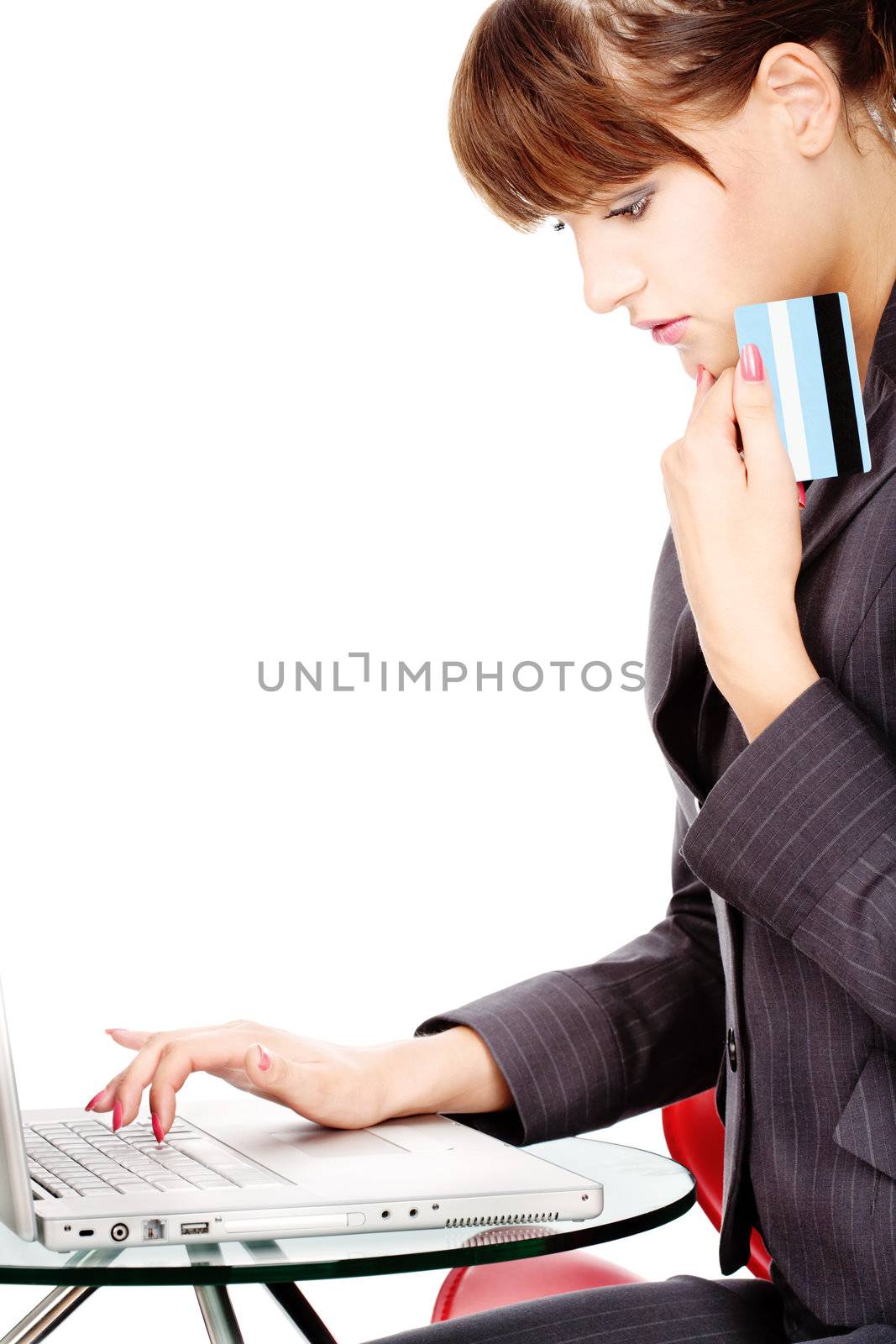 Attractive business woman shopping on line with credit card, isolated on white