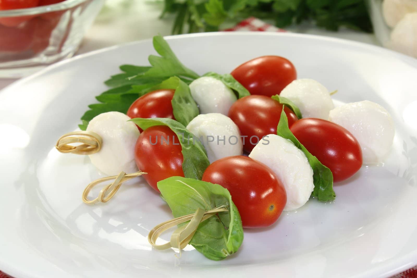 small skewers with mozzarella, tomato and basil