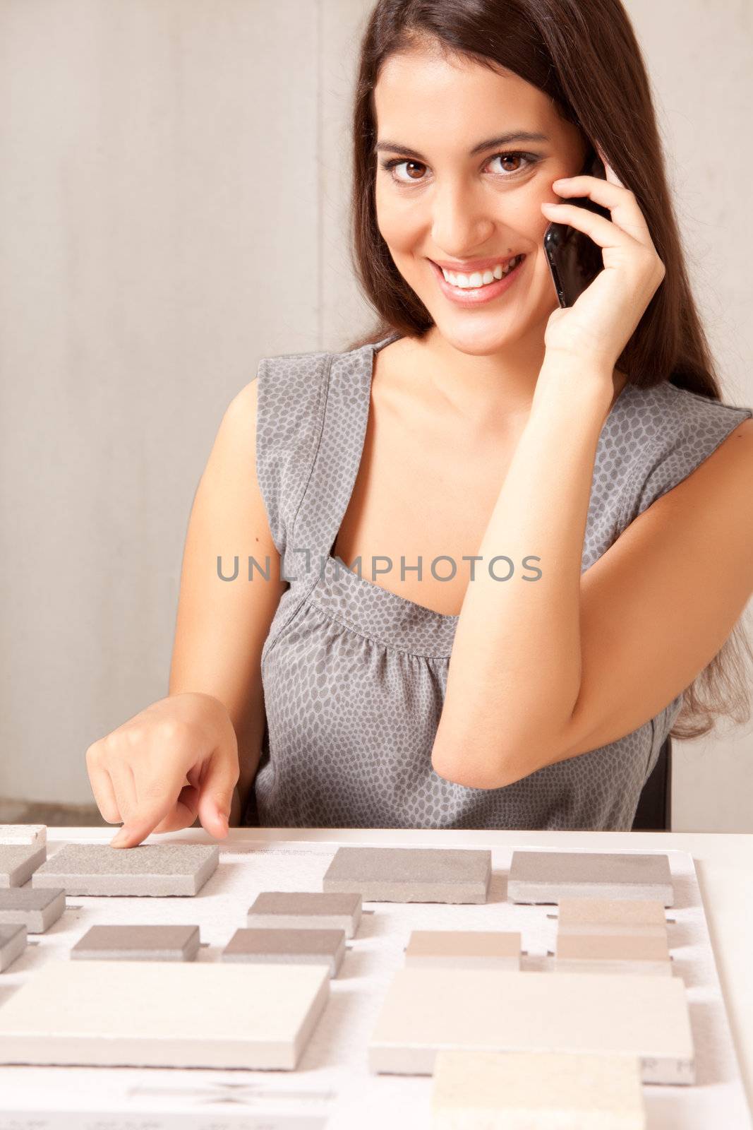 A designer talking on the phone choosing a stone tile
