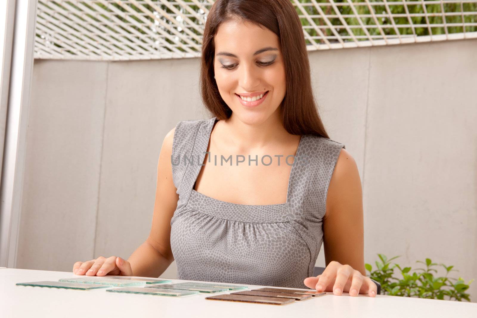 A female interior architect looking at glass tile swatches