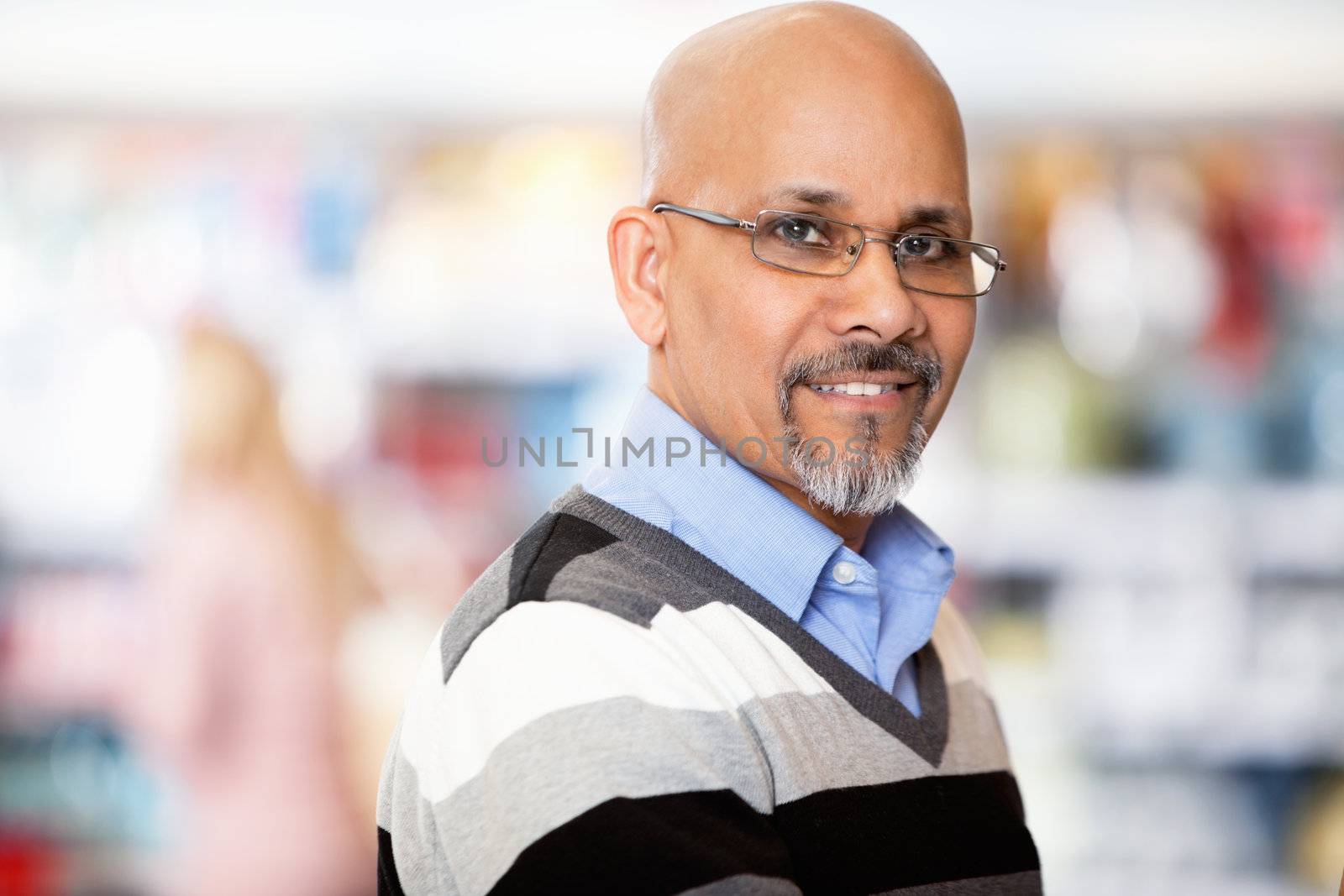 Mature man smiling while shopping in the supermarket