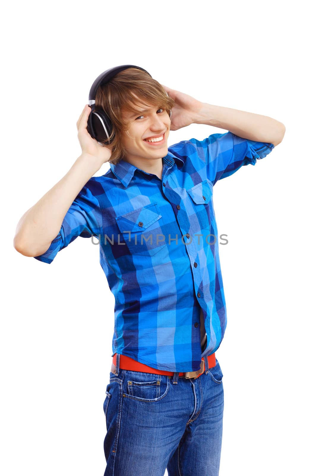 Happy smiling young man dancing and listening to music