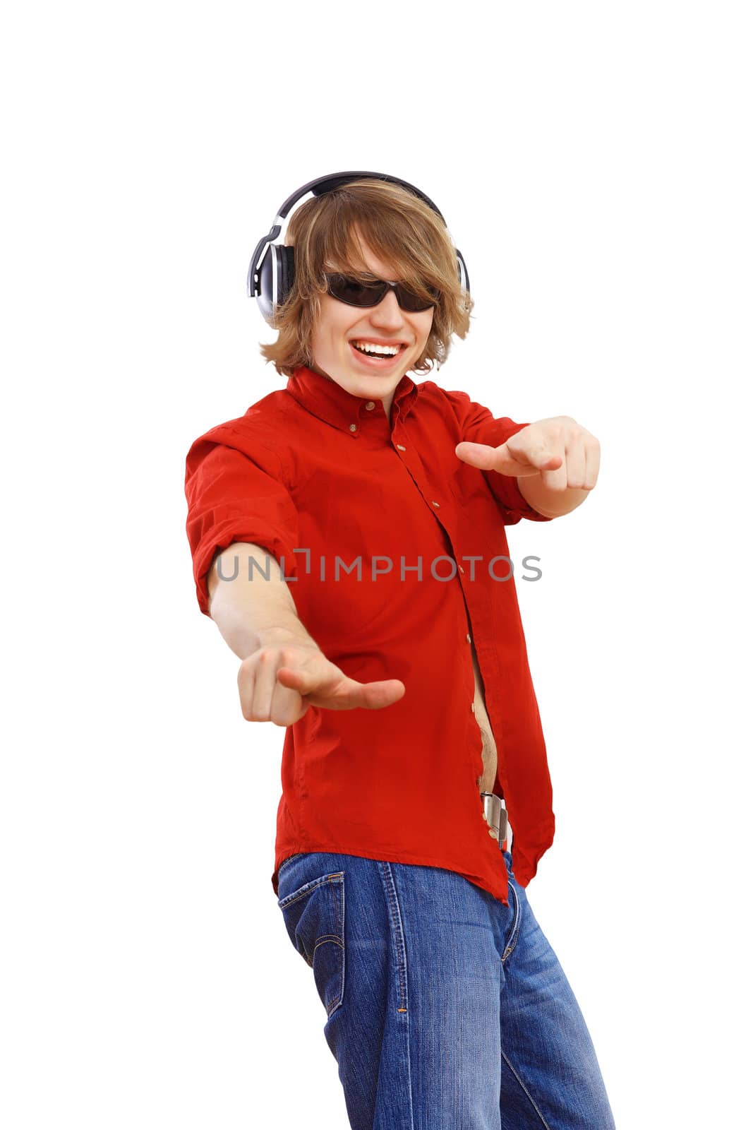 Happy smiling young man dancing and listening to music