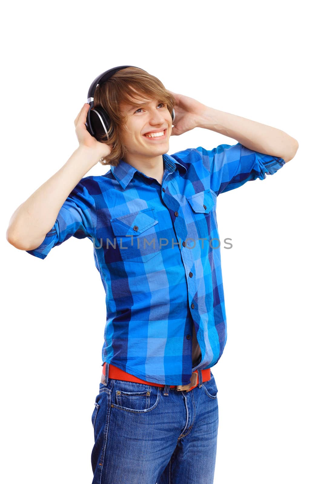 Happy smiling young man dancing and listening to music