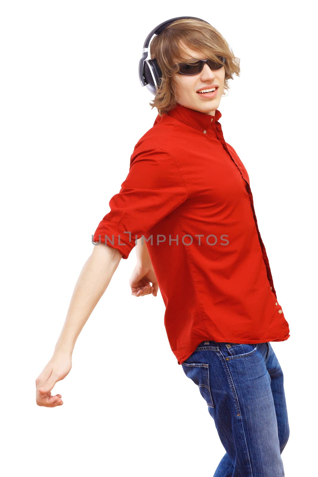 Happy smiling young man dancing and listening to music