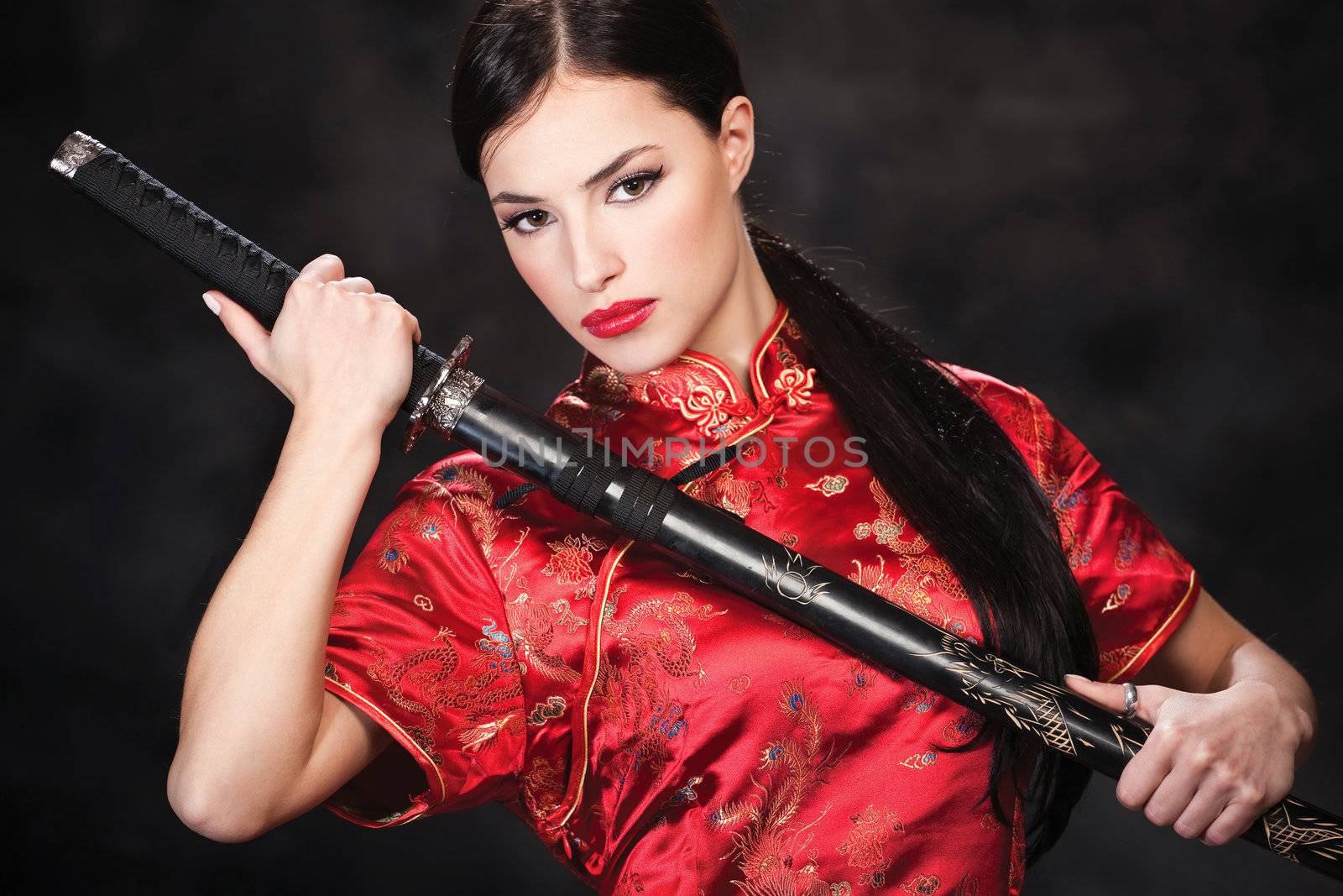 Pretty woman holding katana weapon