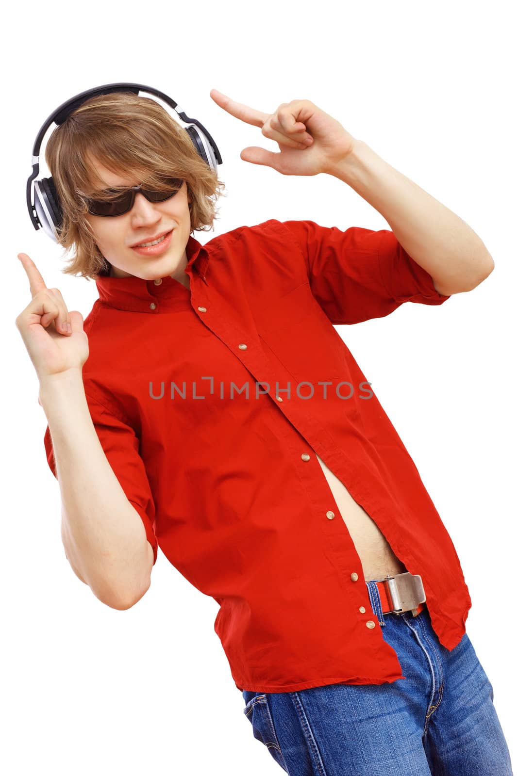 Happy smiling young man dancing and listening to music