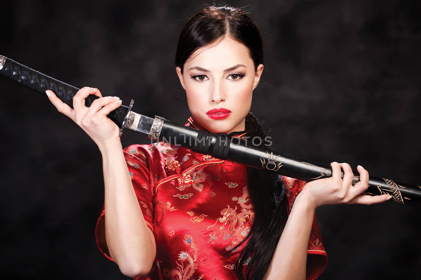 Pretty woman holding katana weapon