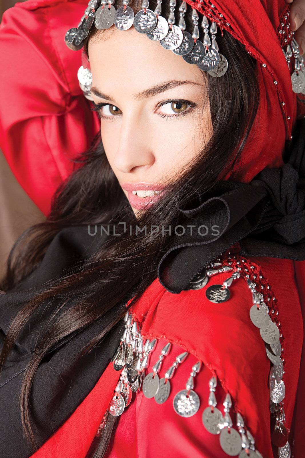 portrait of a beautiful young girl cover with red scarf