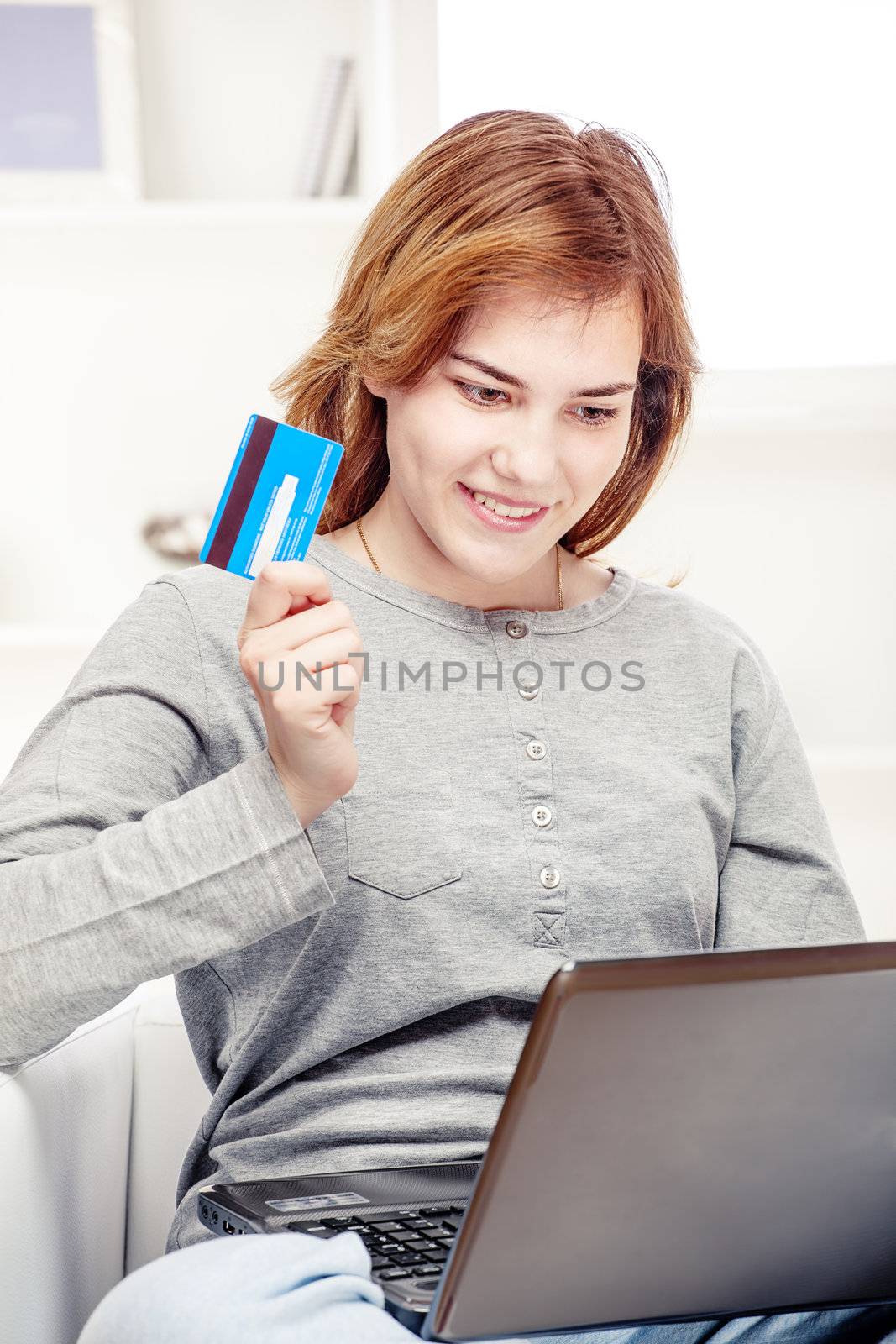 Happy girl doing on line shopping with credit card by imarin