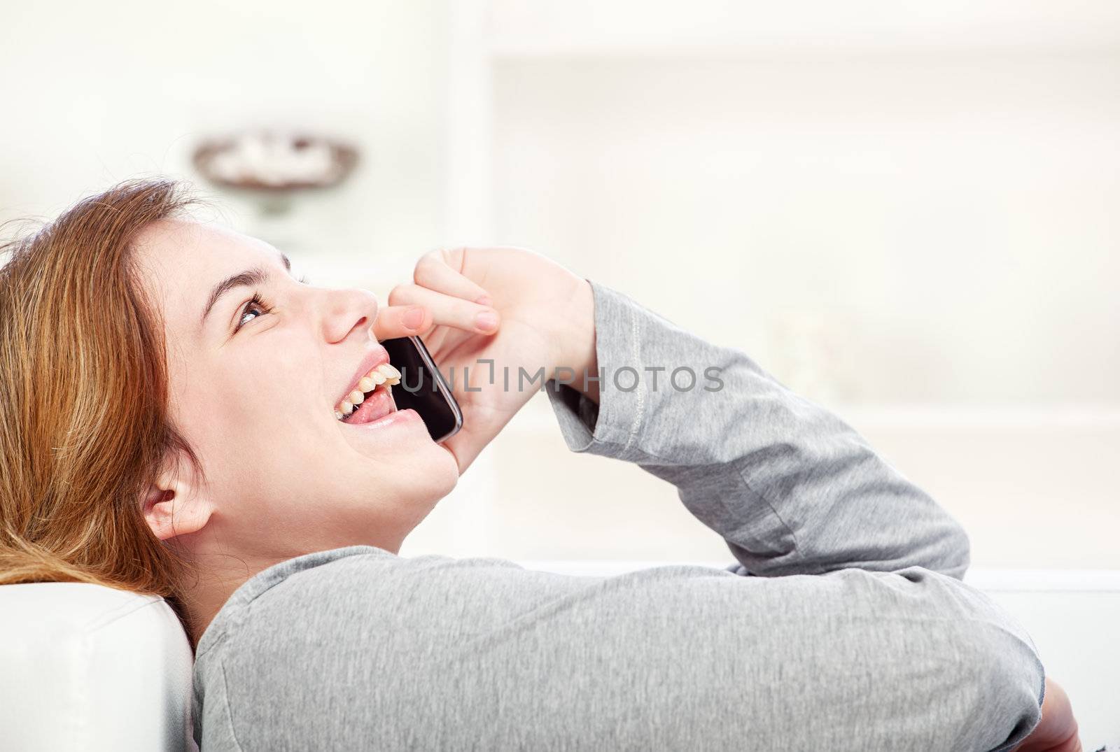 woman have joyful talk over telephone by imarin