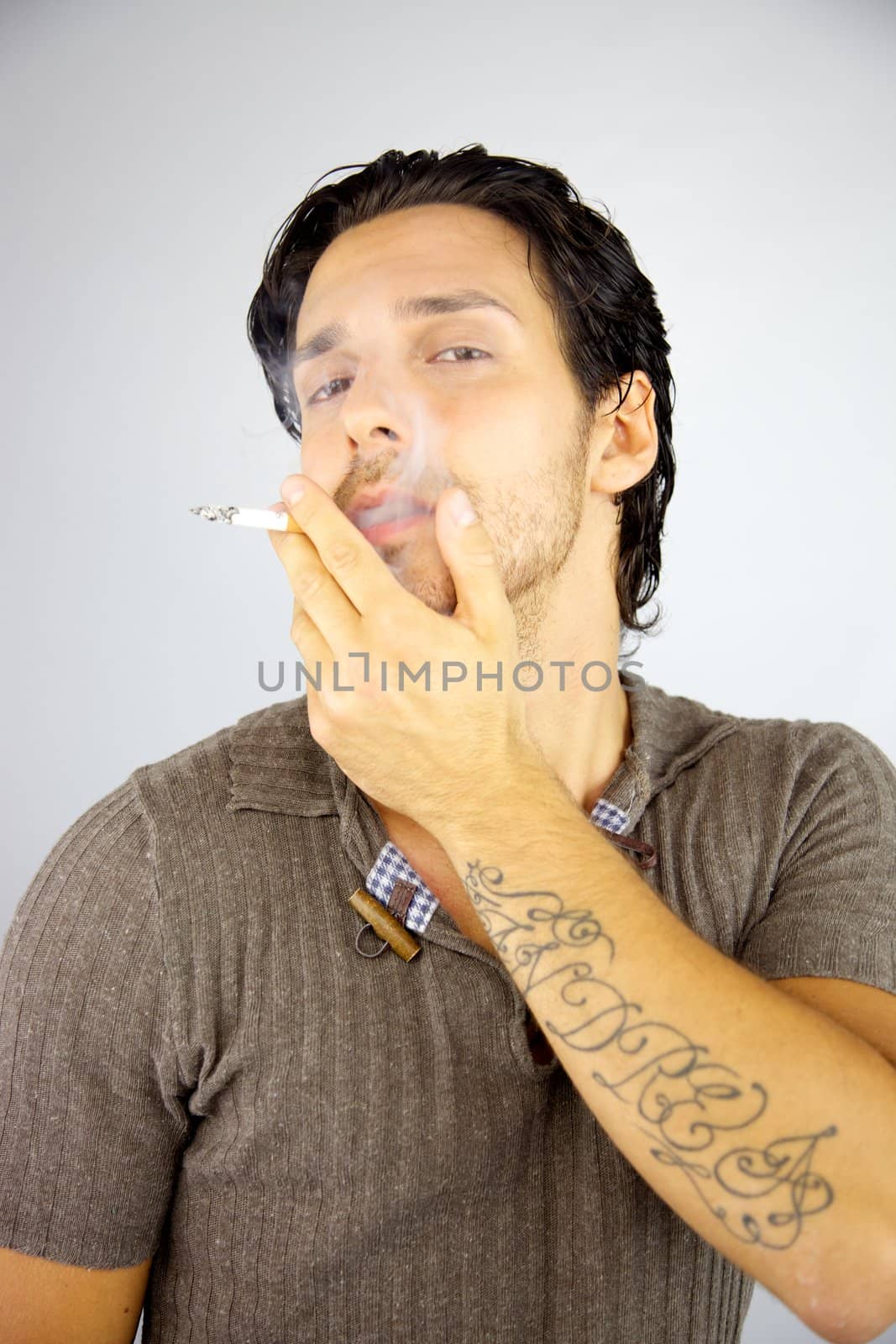 Cool man smoking cigarette enjoying happy
