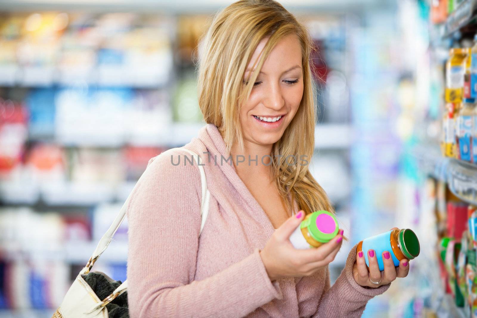 Closeup of a young woman smiling while holding jar by leaf