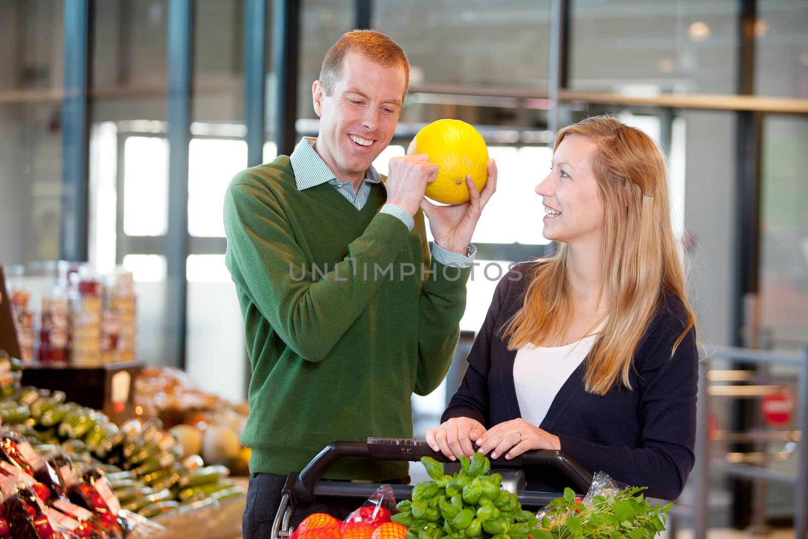 A man knocking on a melon to check if it is ripe