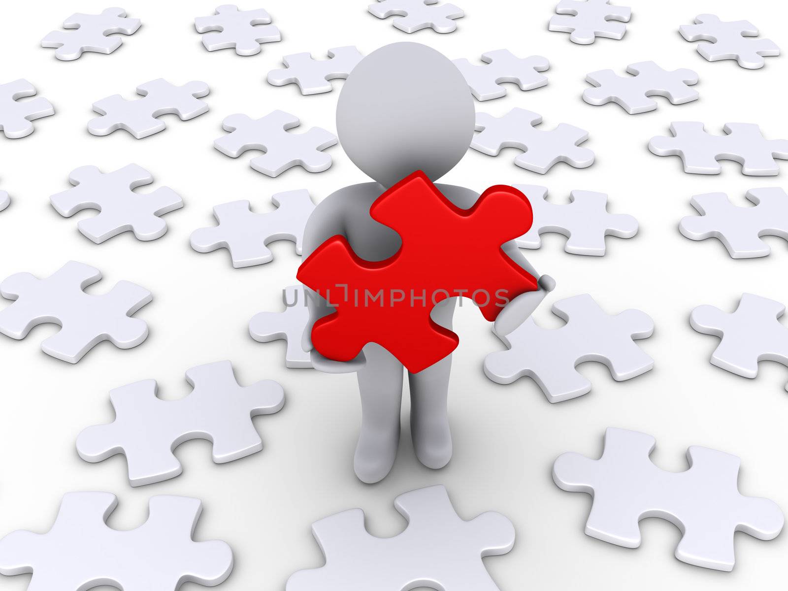 3d person holding a red puzzle piece and other white ones lying on the ground